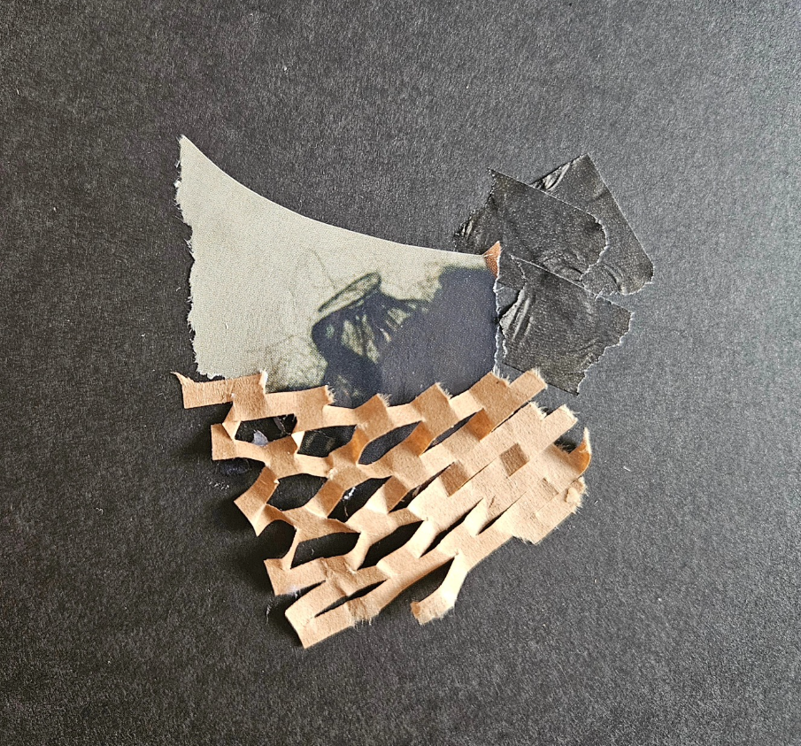 A torn piece of paper with a butterfly shadow and a piece of crumpled brown paper underneath.