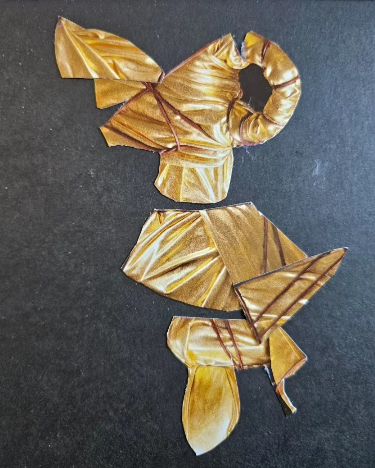 Artistic representation of an elephant made from crumpled golden-brown paper on a dark background.