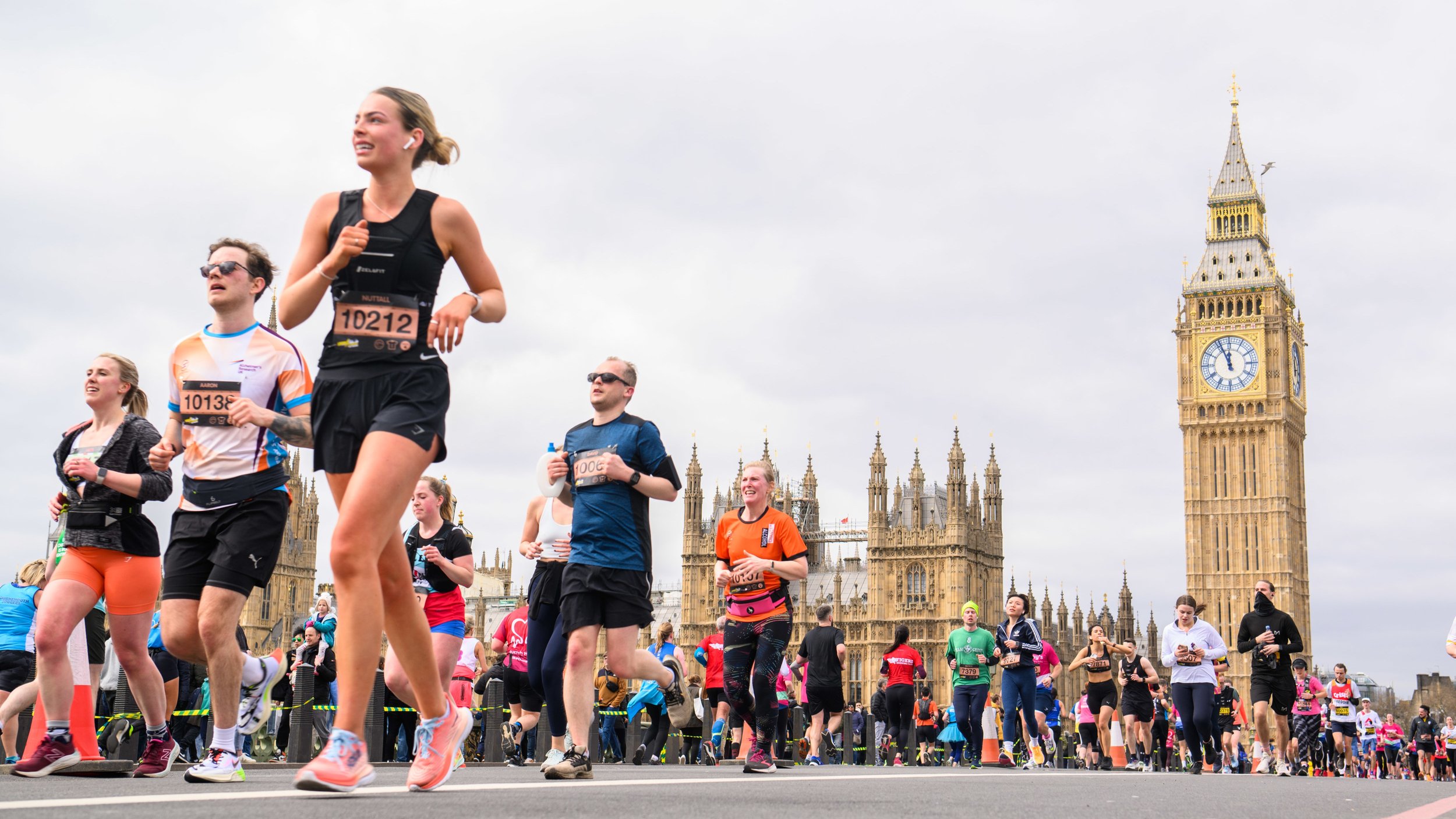 Marathon runners crossing the finish line in front of Big Ben in London.