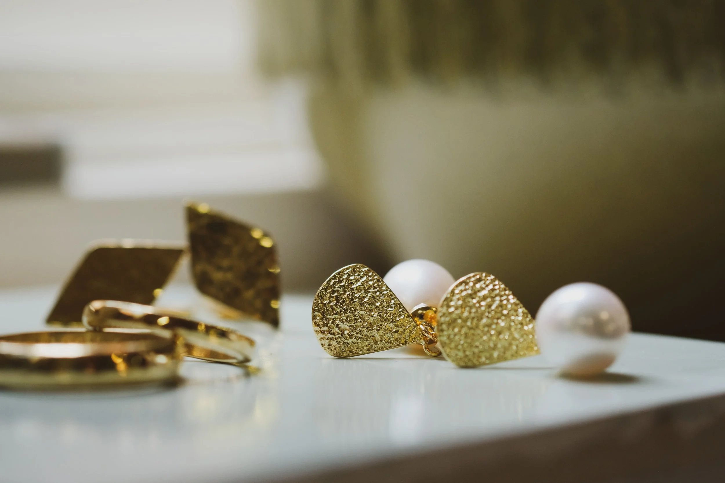 Handgemaakte oorringen met parel, trouwringen en manchetknopen 18k goud door Salvador Jewels uit Brugge