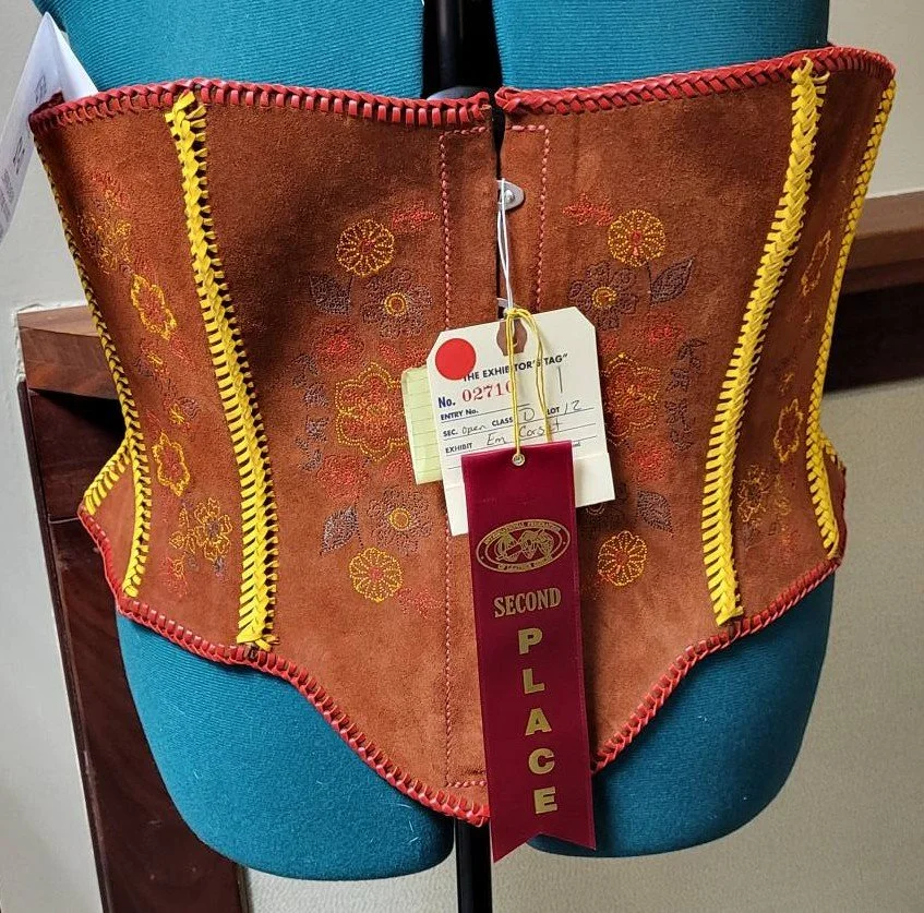 Embroidery, lacing and leather.  All come together for this corset