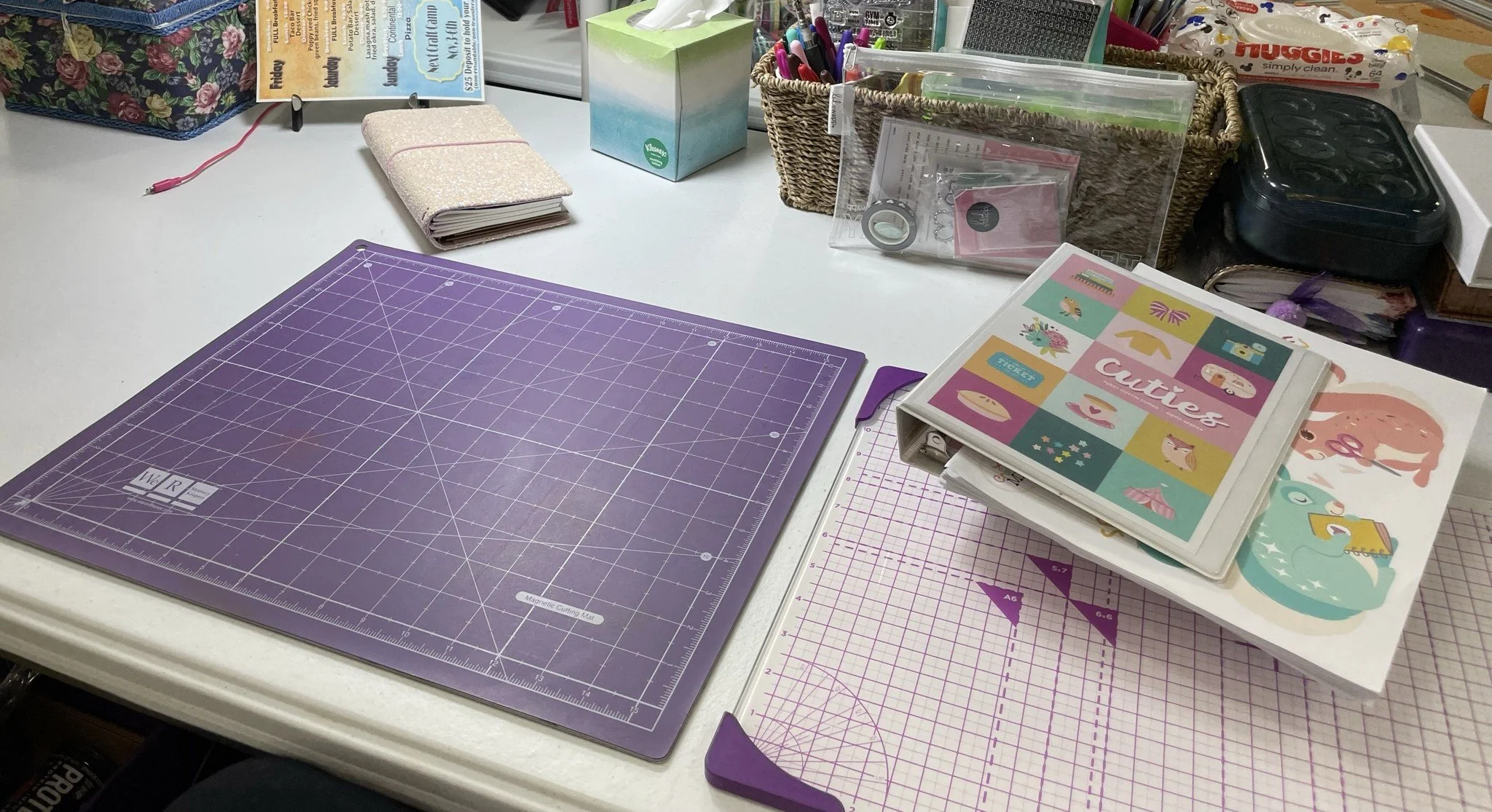 Crafting supplies including cutting mat, washi tape, and scrapbook materials at Creekside Crafters women's retreat in Watertown, Tennessee