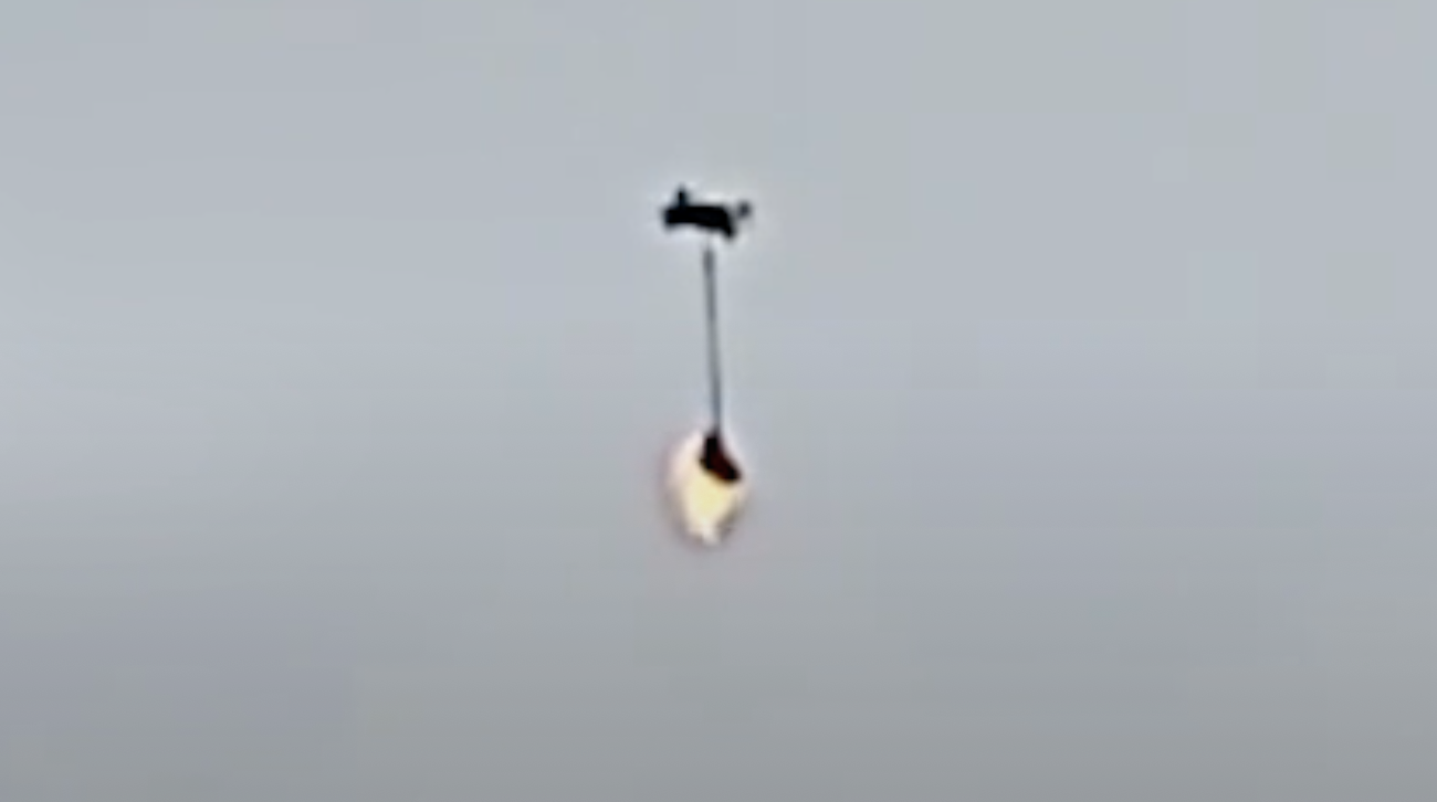 UAV drone equipped with fireball to burn hole in anti-drone prison yard net