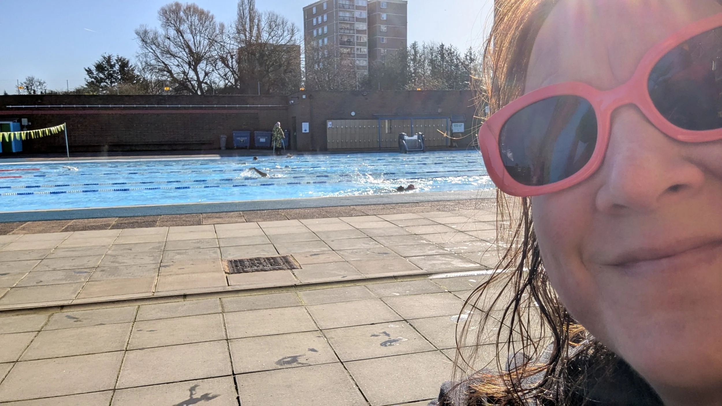 Gail Glennie outside Charlton Lido swimming pool on a sunny winter's day