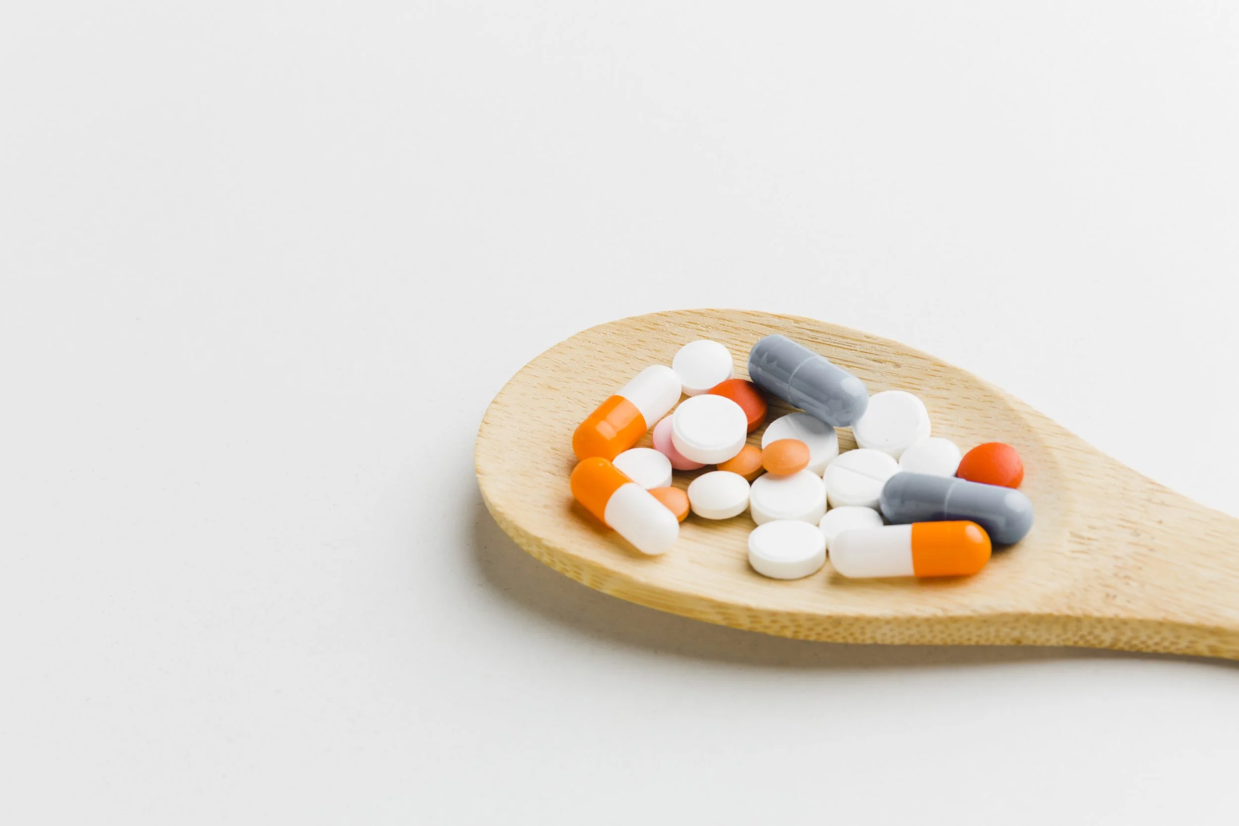 a spoon filled with pills or medicines