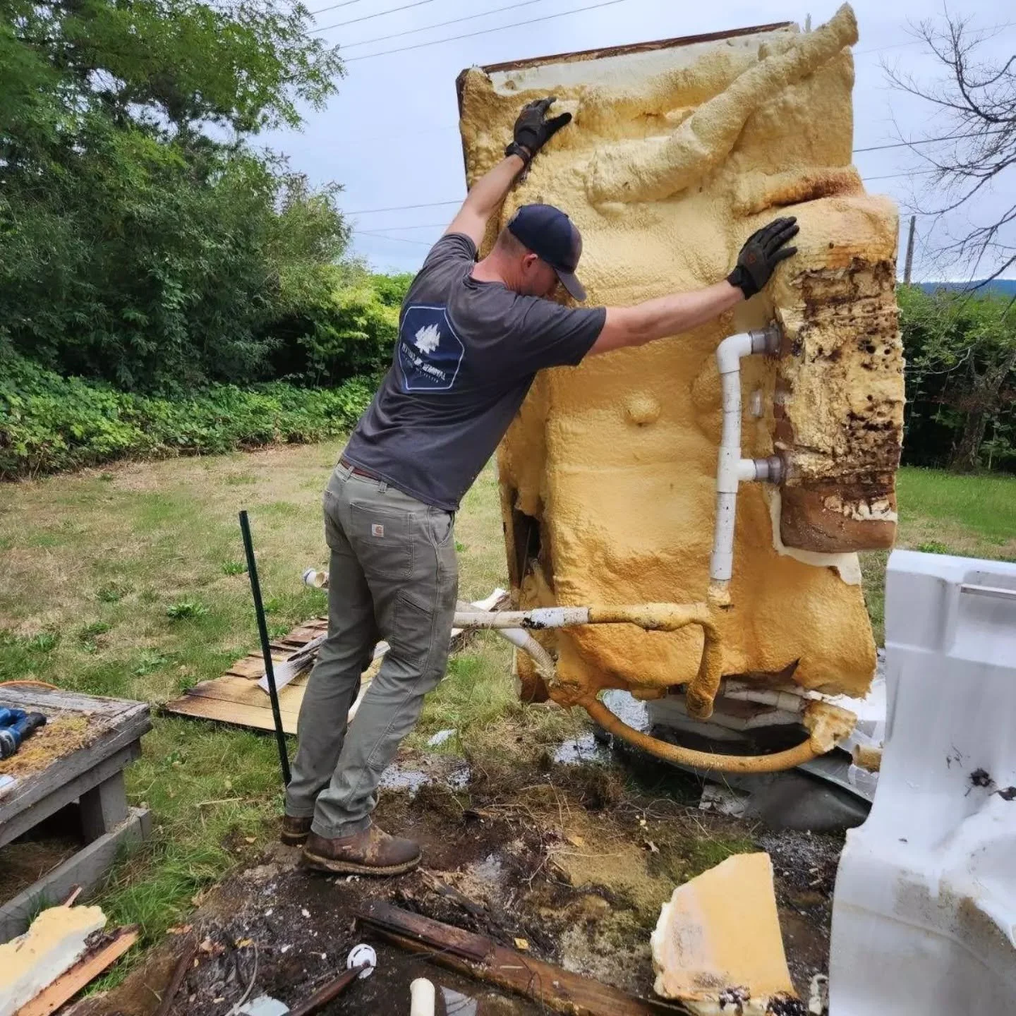 Yetter's Junk Removal removing a dismantled and broken hot tub unit.
