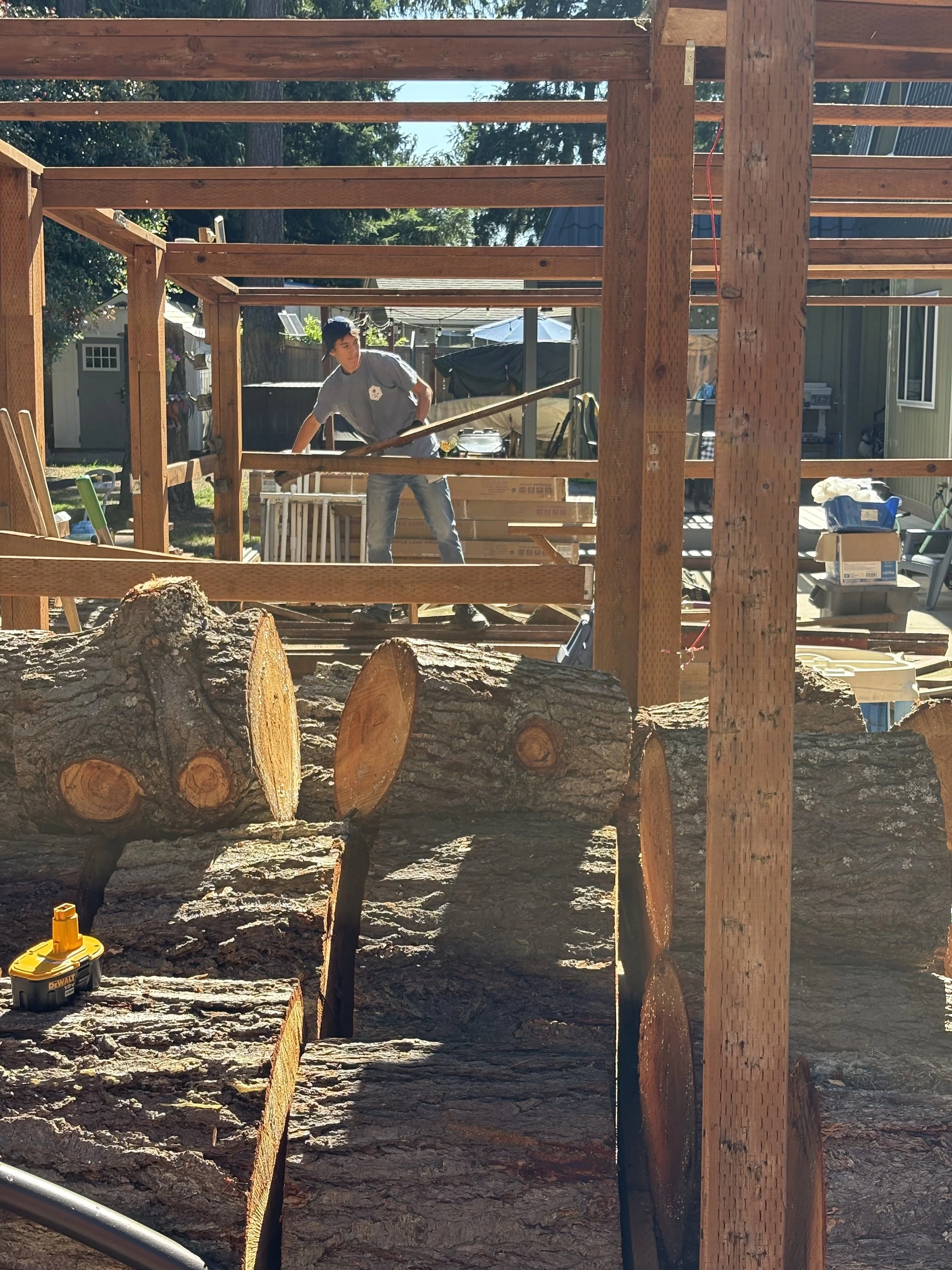 Jude working on removing a wooden structure in the backyard of a Bremerton home