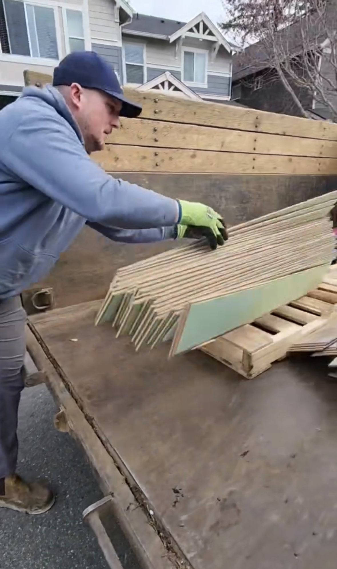 Demo debris Removal with old flooring being thrown into trailer
