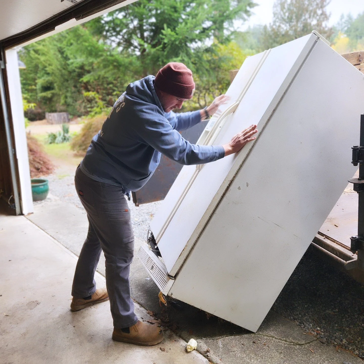 Yetter's Junk Removal removing heavy refrigerator from garage in Bremerton
