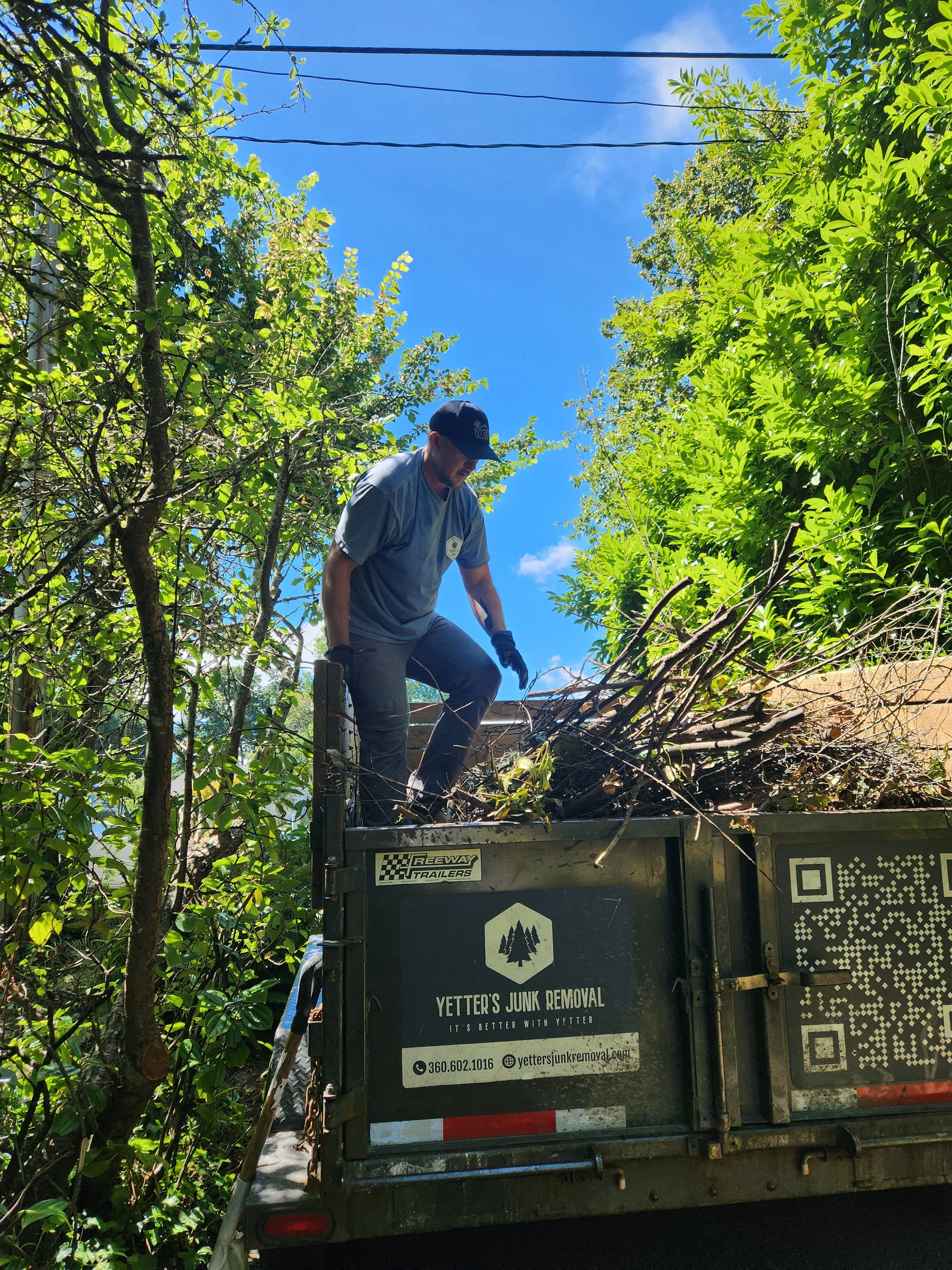 Owner of Yetter's Junk Removal, Mat, clearing away branches from yard in Silverdale