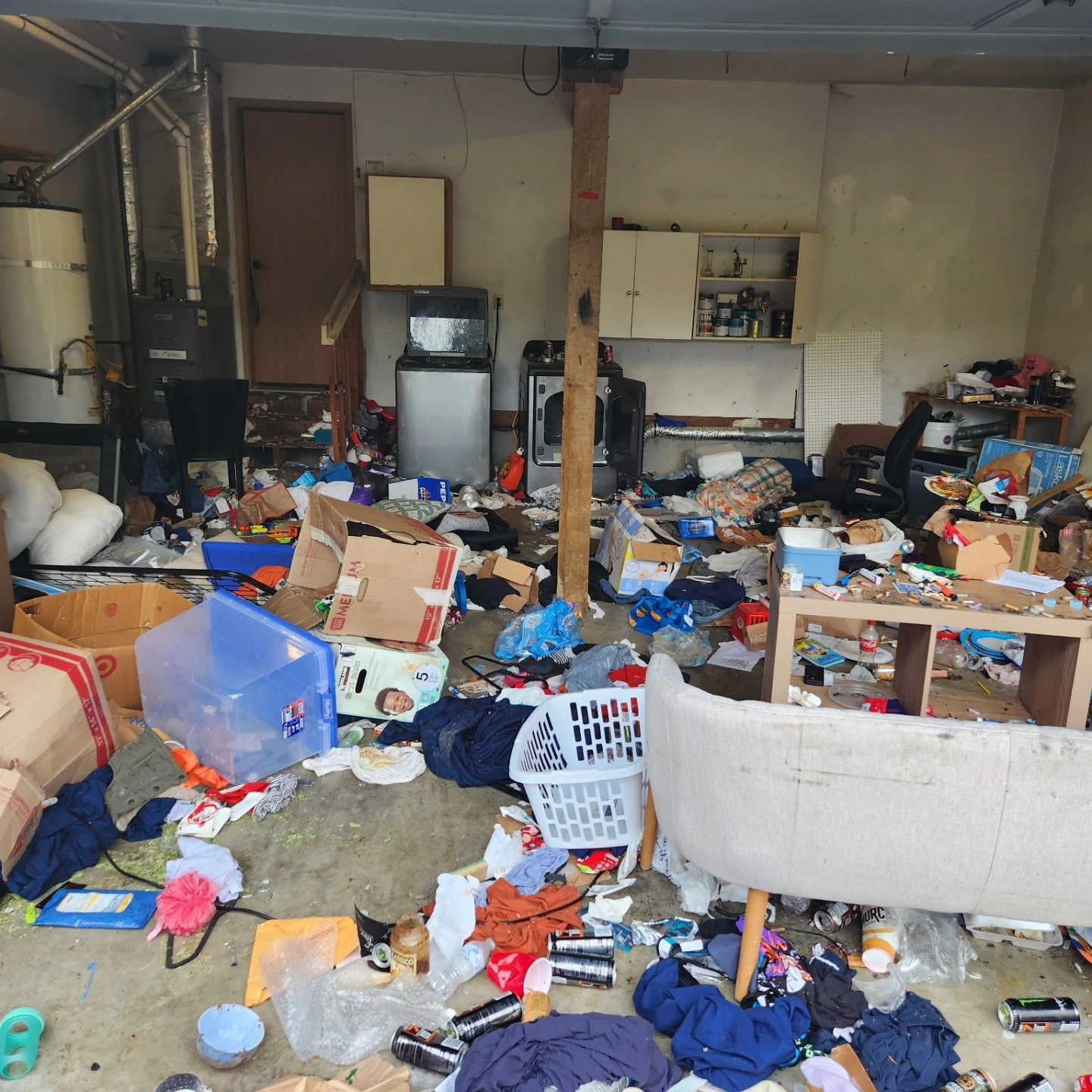 garage cleanout before picture full of junk, clothing items, bedding, home items
