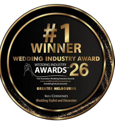 Gold and black circular award badge for wedding industry, stating '#1 Winner Wedding Industry Award 26' with a wedding dress icon, awarded to a wedding stylist and decorator in Greater Melbourne.