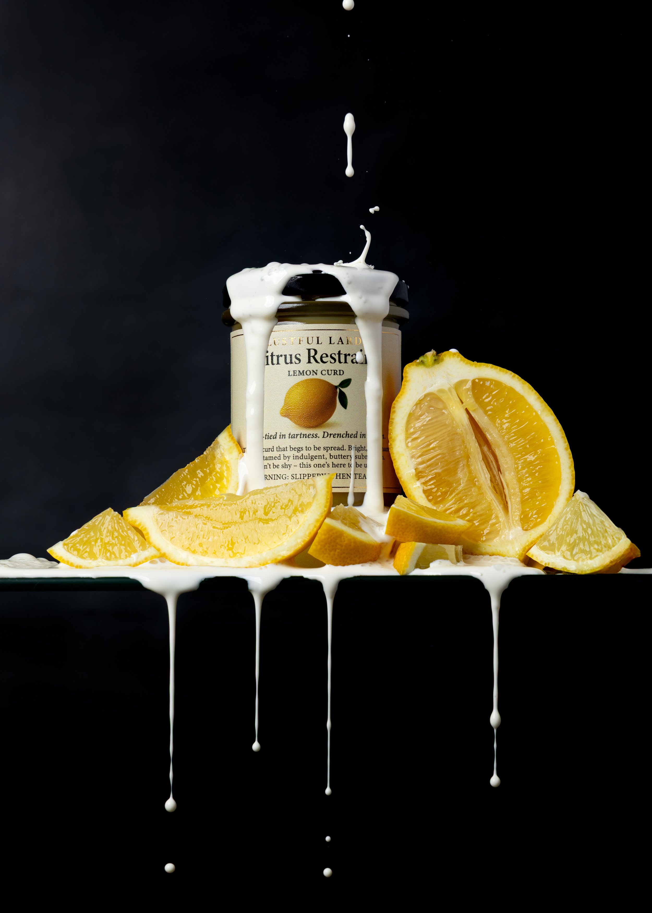 A jar of citrus lemon curd with lemon slices and white cream spilling over, on a dark background with cream dripping down the edge of the surface.