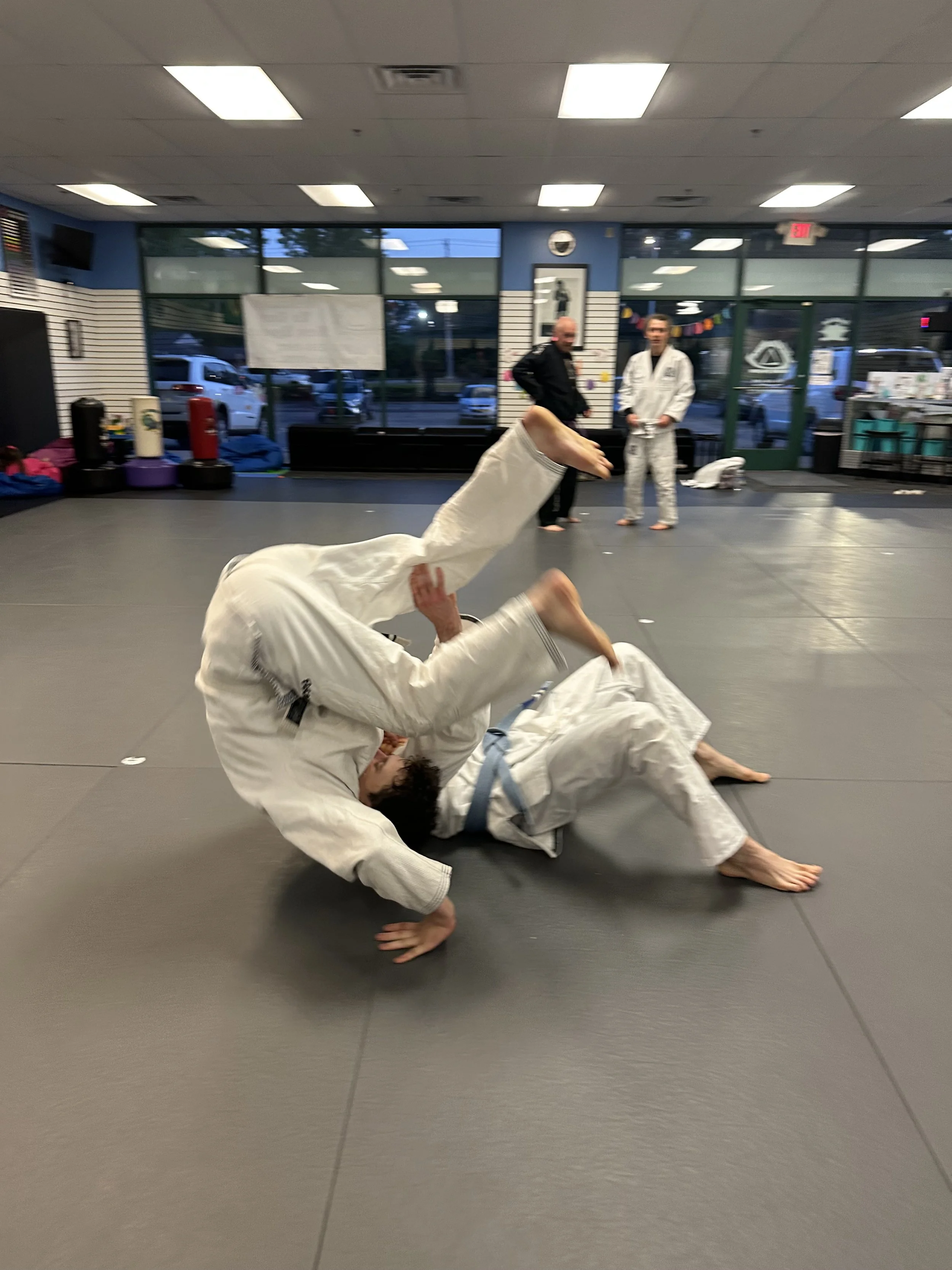 Using technique and leverage over power and strength, training partners work together to improve their self-defense and grappling skills.