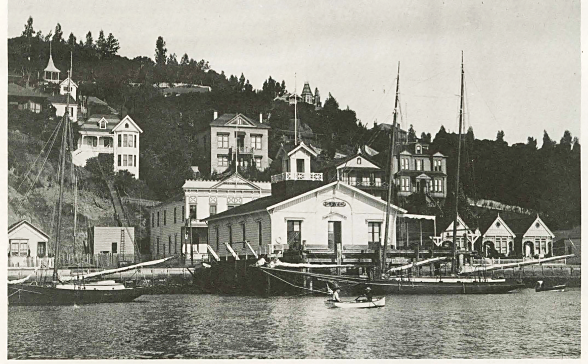 Original SFYC clubhouse in Sausalito circa 1890, with the schooner CHISPA docked in front.