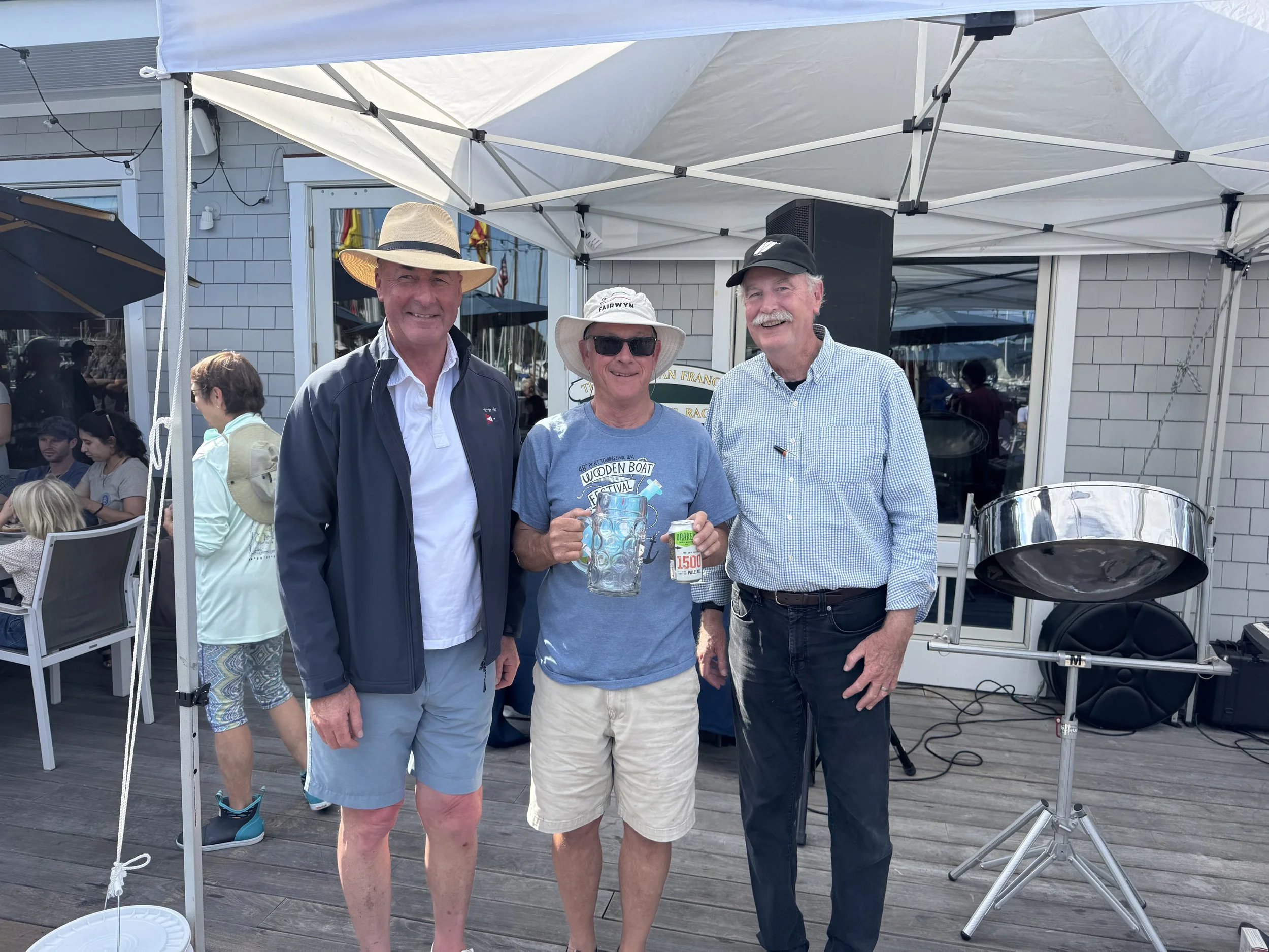 Richard Leland, skipper of Fairwyn, receiving the 2nd place trophy for the Classic Yacht II fleet from Jr. S/C Quentin Hill and S/C John Swain.