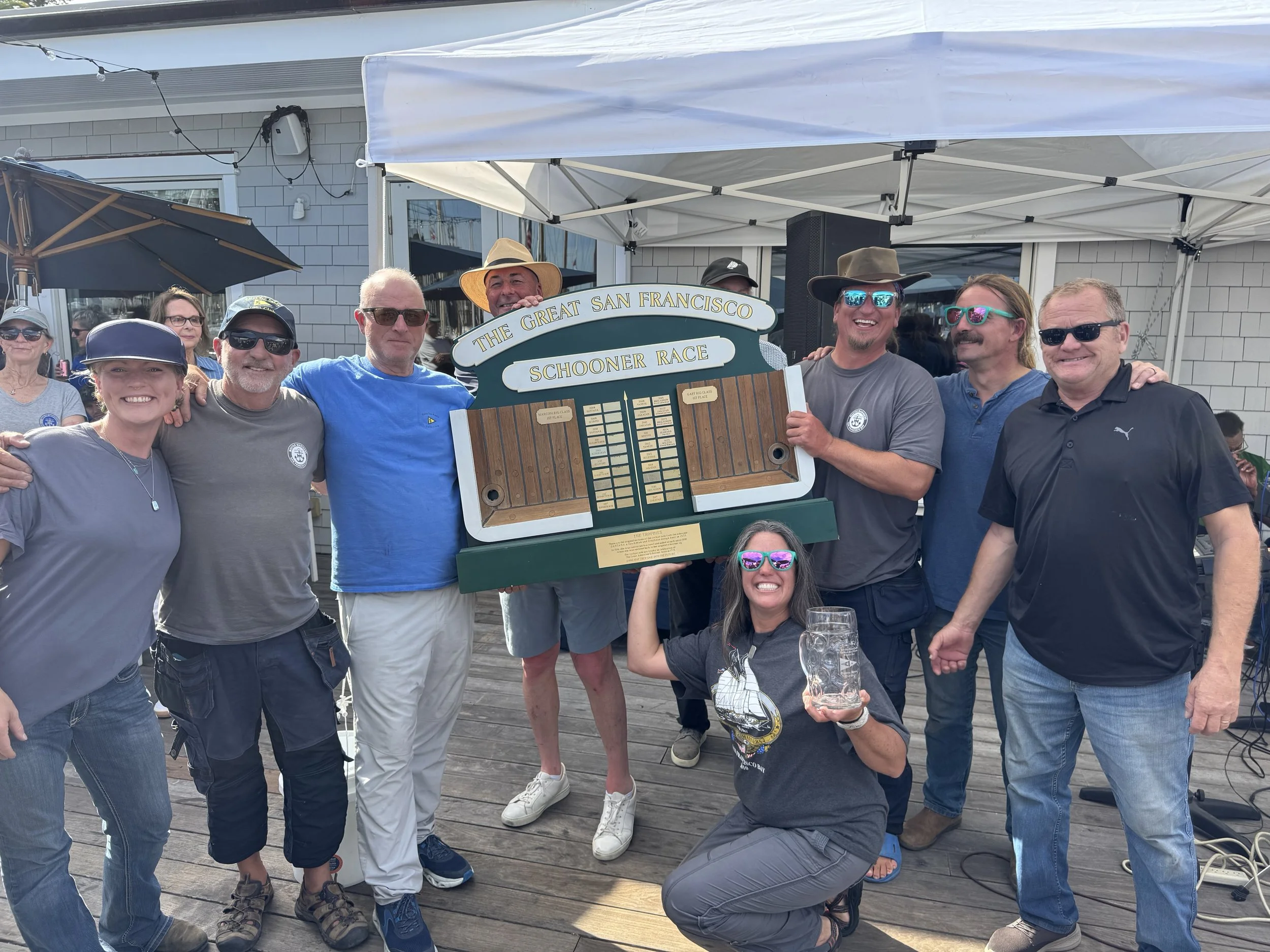 Andy Flick, owner of Brigadoon, and crew receiving their 1st place trophy for the Schooner fleet from Jr. S/C Quentin Hill, S/C John Swain.