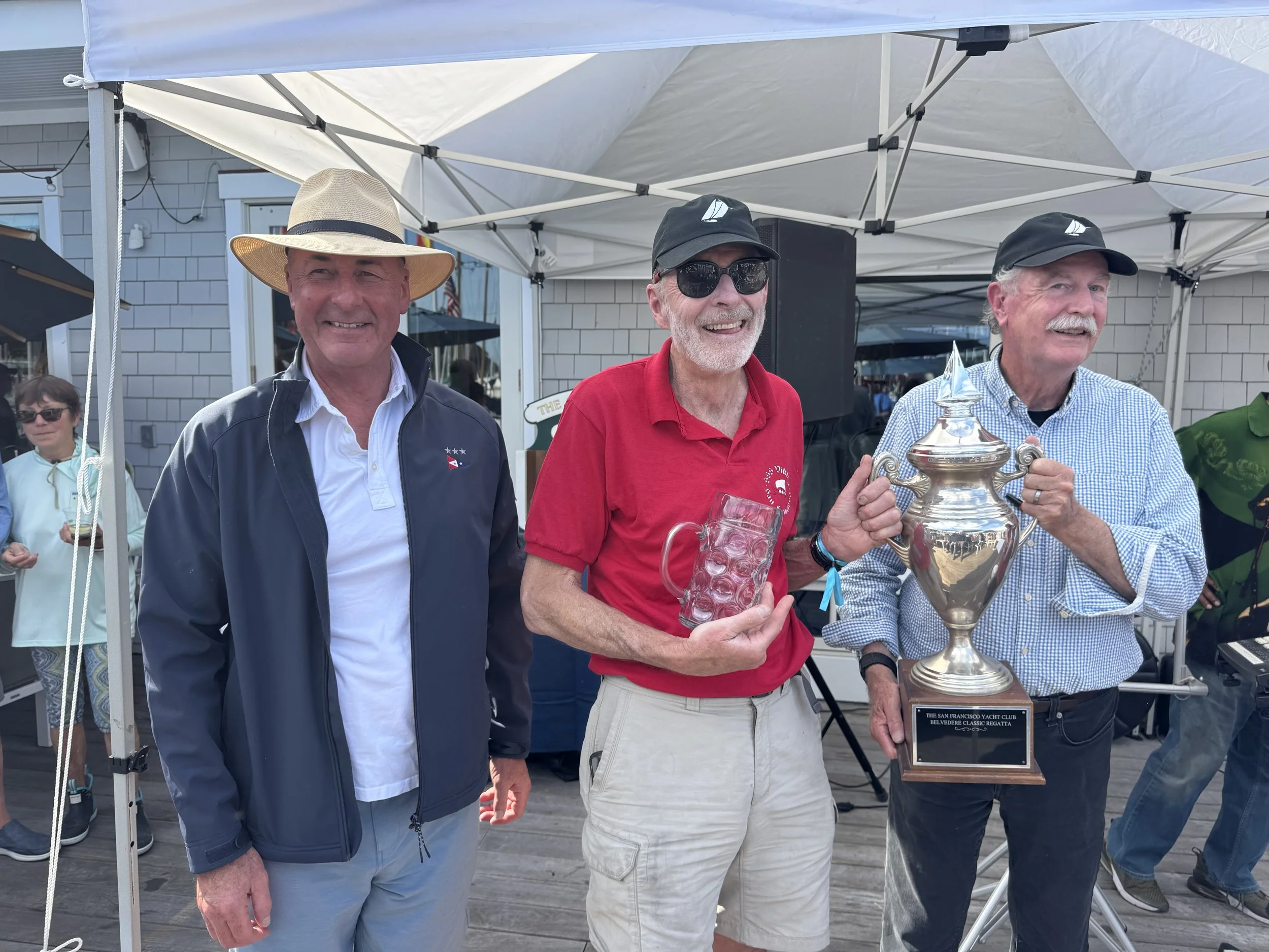 Mike O'Callaghan, skipper of Viking, receiving the 1st place trophy for the Classic Yacht II fleet from Jr. S/C Quentin Hill and S/C John Swain.