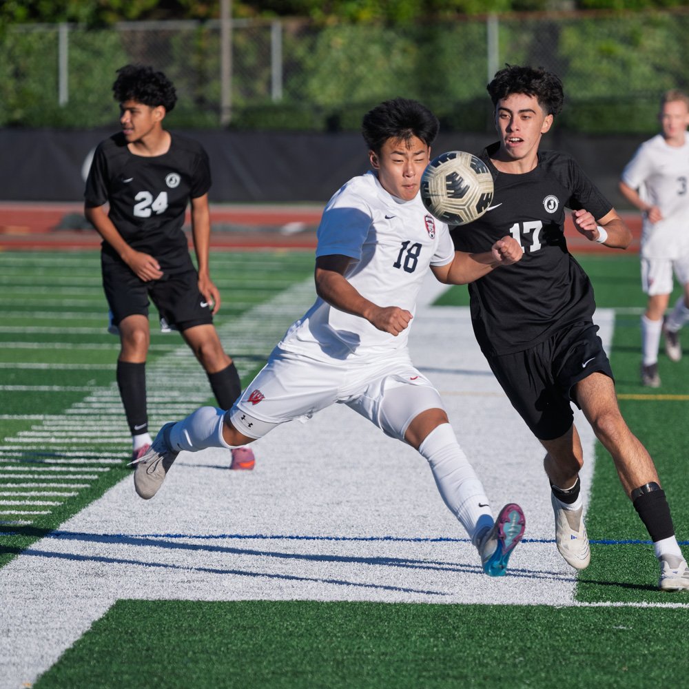 Jesuit JV soccer player battling for the ball against Westview during high school match in Portland Oregon