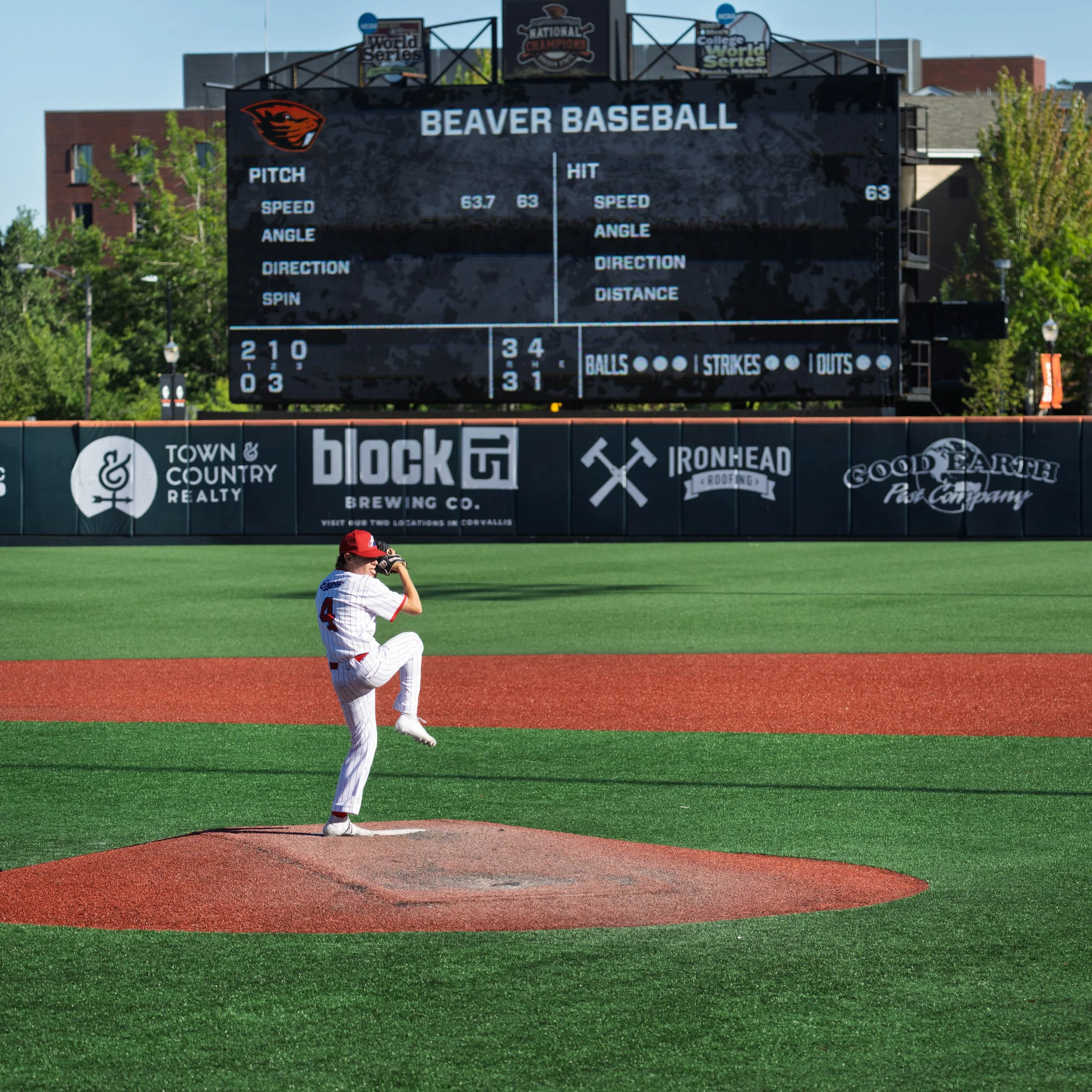 16U baseball pitcher throwing during OSU showcase tournament game action