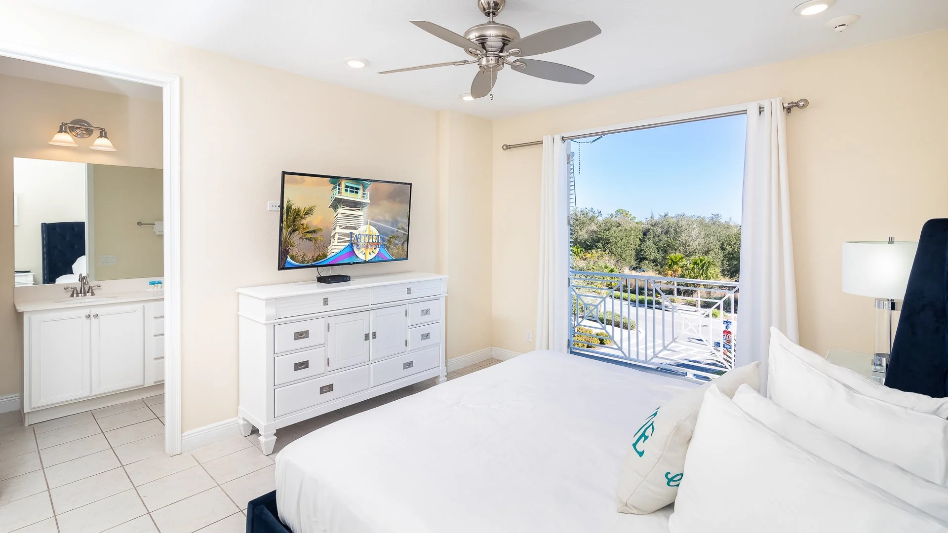 Bright and airy Margaritaville Cottage Seas Life Cottage Primary bedroom with ensuite private bath with balcony overlooking resort
