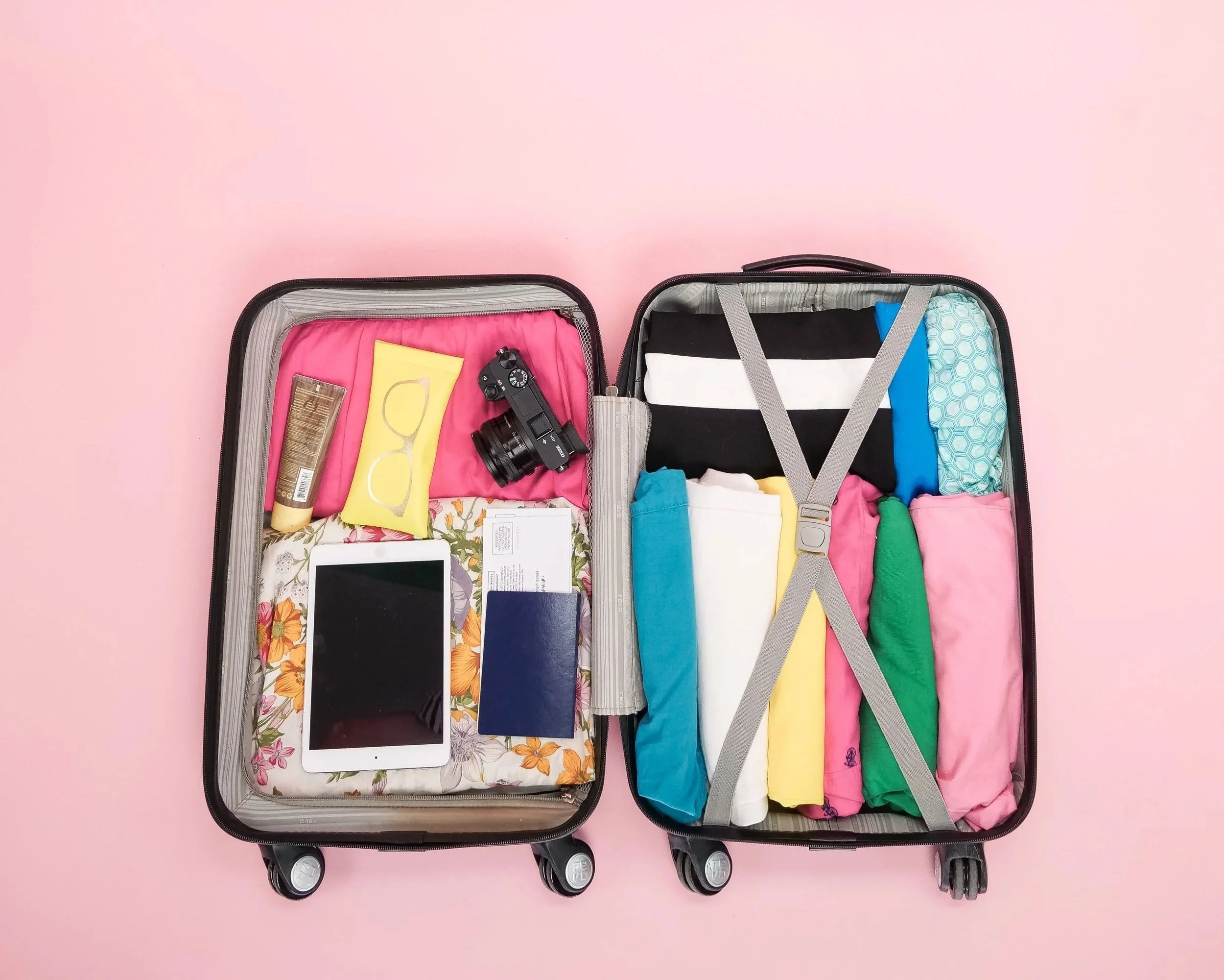 Colorful suitcases with travel essentials before vacation