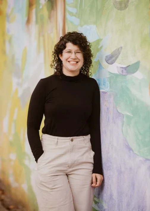 A picture of Christine Ruberti-Bruning ATR-BC, CEDS, LPC, a queer licensed therapist with over 15 years of experience. As someone with trans spouse, she provides therapy to partners and spouses of transgender individuals.