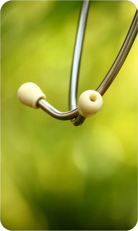 Close-up of a stethoscope against a green blurred background.