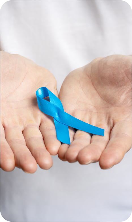 Person holding a blue awareness ribbon in their open palms.