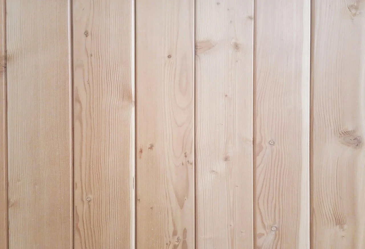 Close-up of light-colored wooden planks with visible grain and knots.