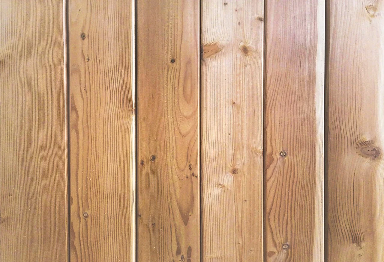 Close-up of vertical wooden planks with visible wood grain and knots.