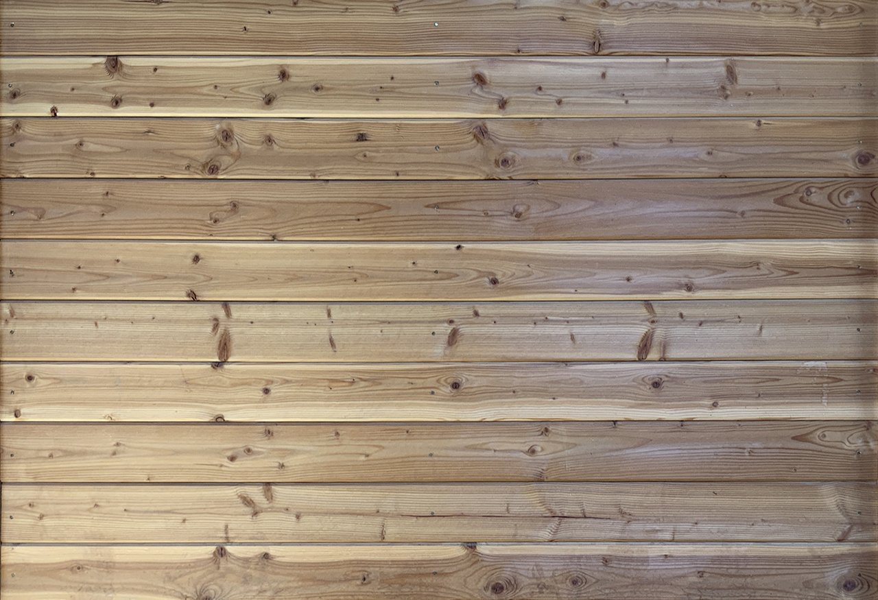 Wooden horizontal planks with visible knots and grain patterns.
