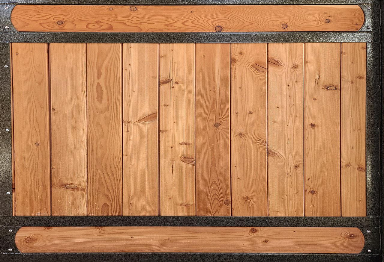 A wooden pet gate or barrier with vertical planks and rounded top and bottom rails framed in metal.
