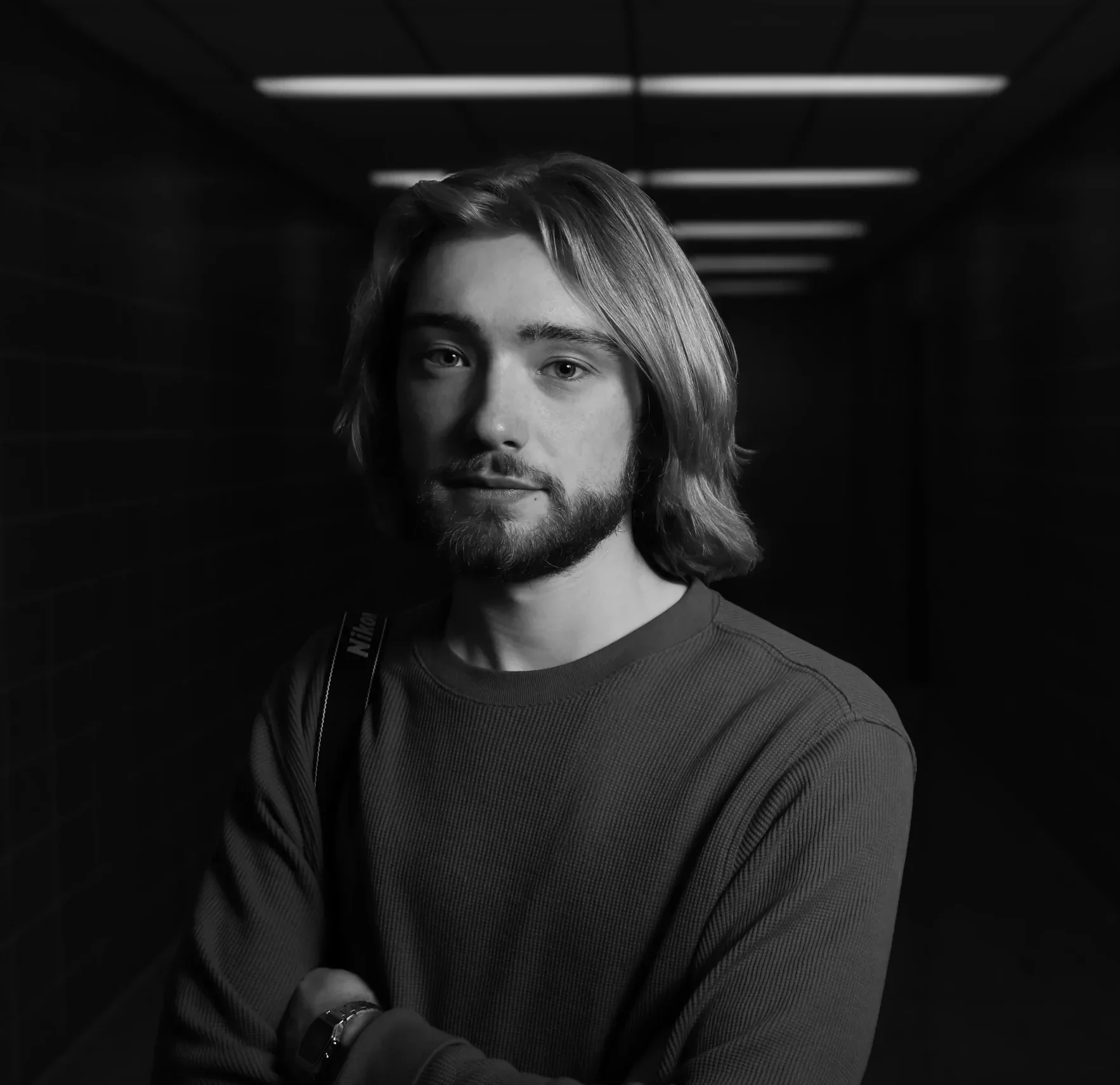Professional headshot of a professional photographer photographed in SAIT Calgary. 