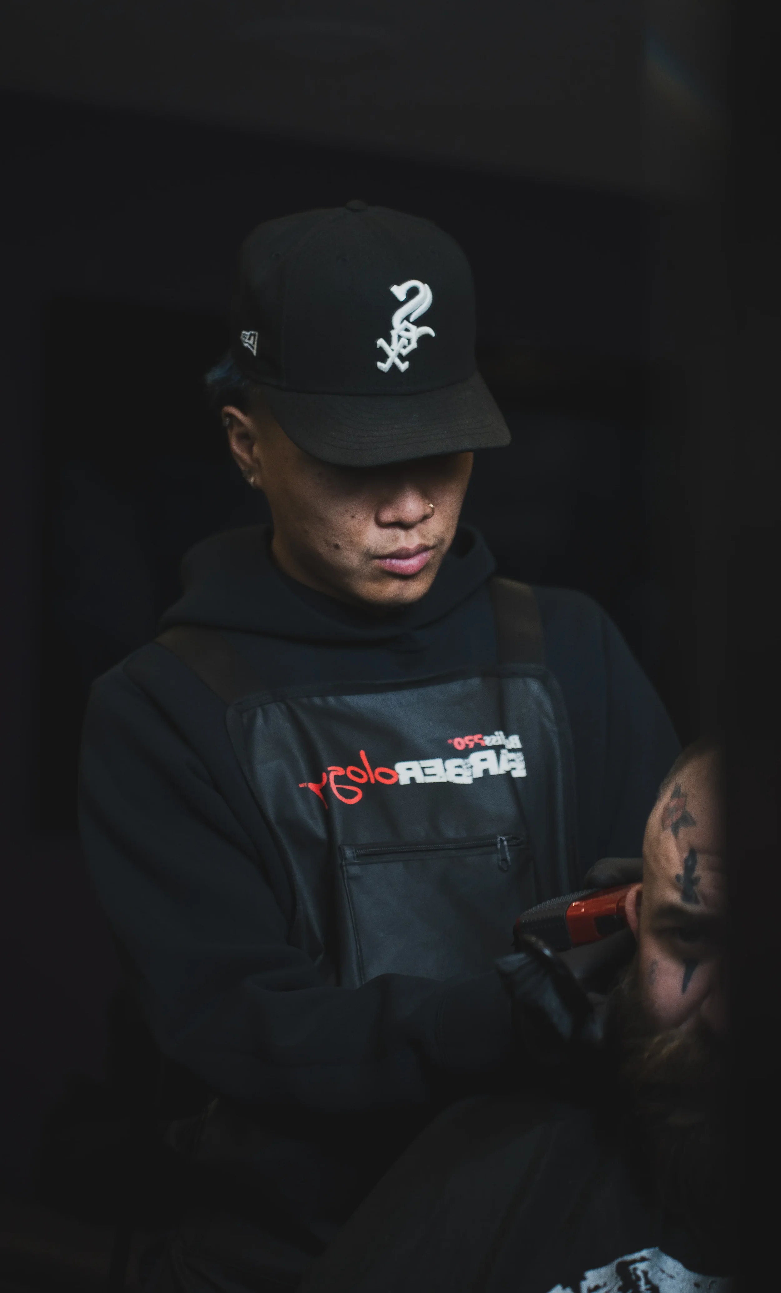 A branding image of a barber in Calgary working on a client.