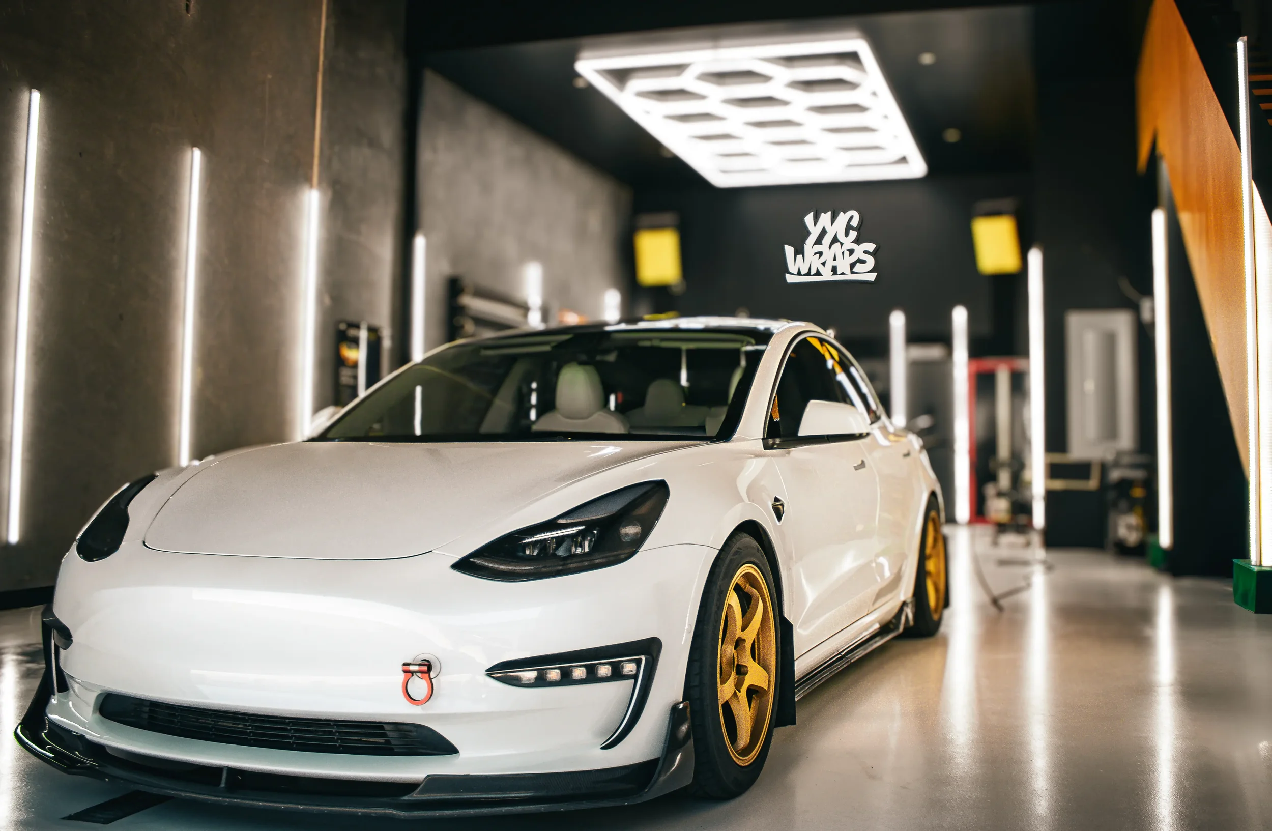 Portrait of a tesla for a car wrap company inside their garage.