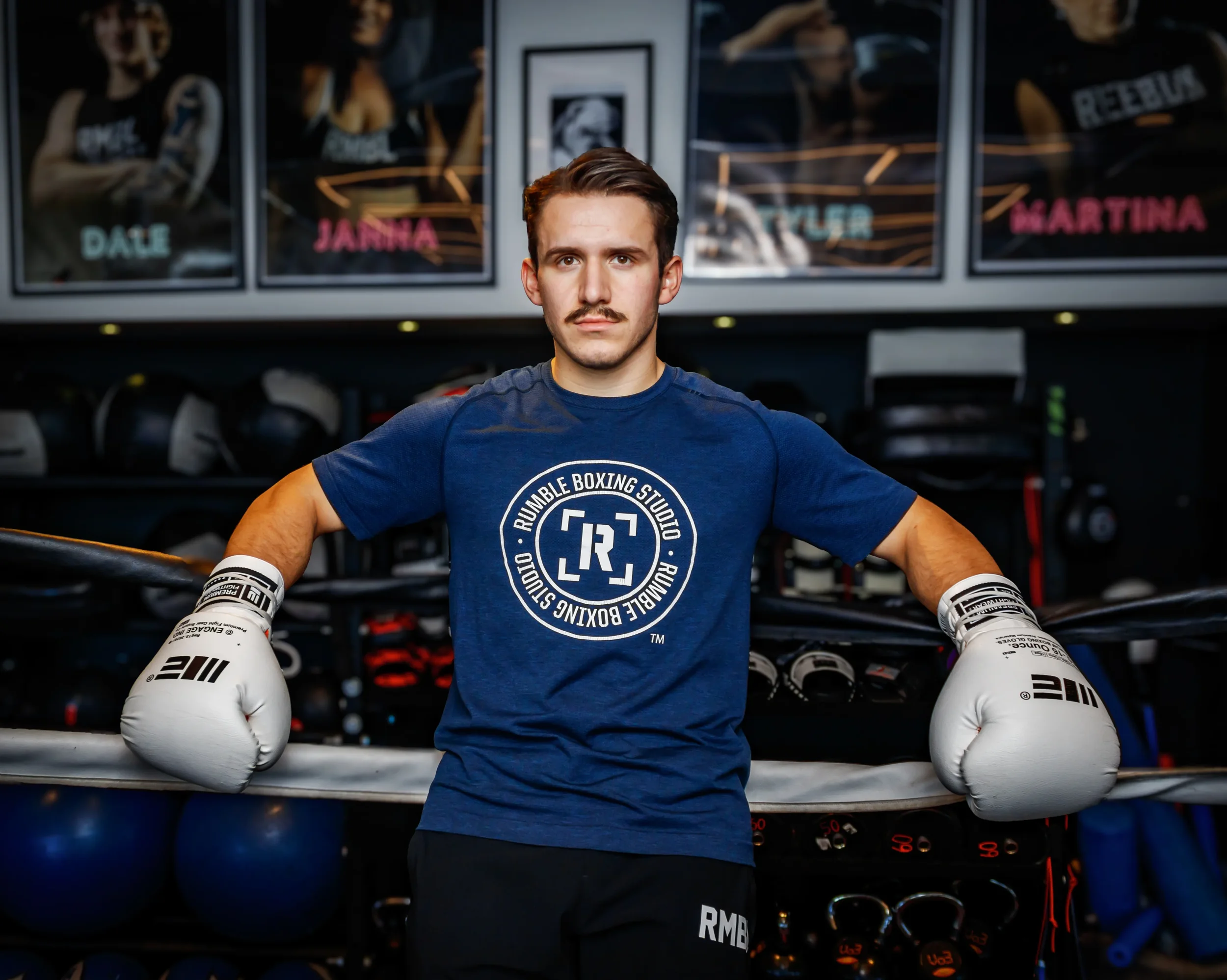A branding photo of a boxing coach at Rumble boxing studio.