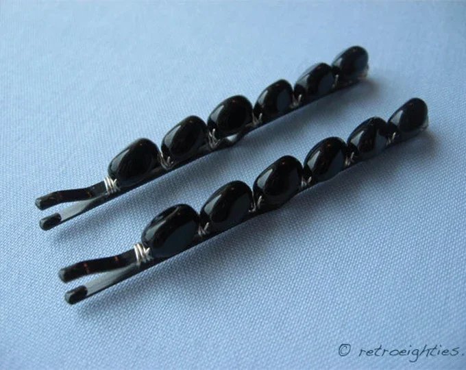 Black beaded bobby pins on the blue background