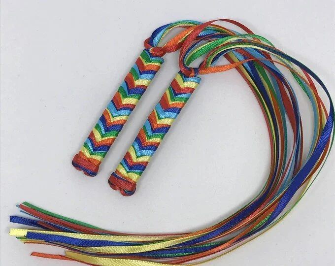 Custom 1980s-inspired braided ribbon barrettes with red, yellow, green, blue, and purple ribbons.