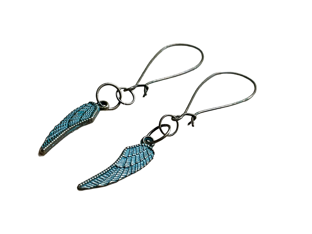 Pair of antique brass earrings with turquoise feather-shaped pendants on a white background.
