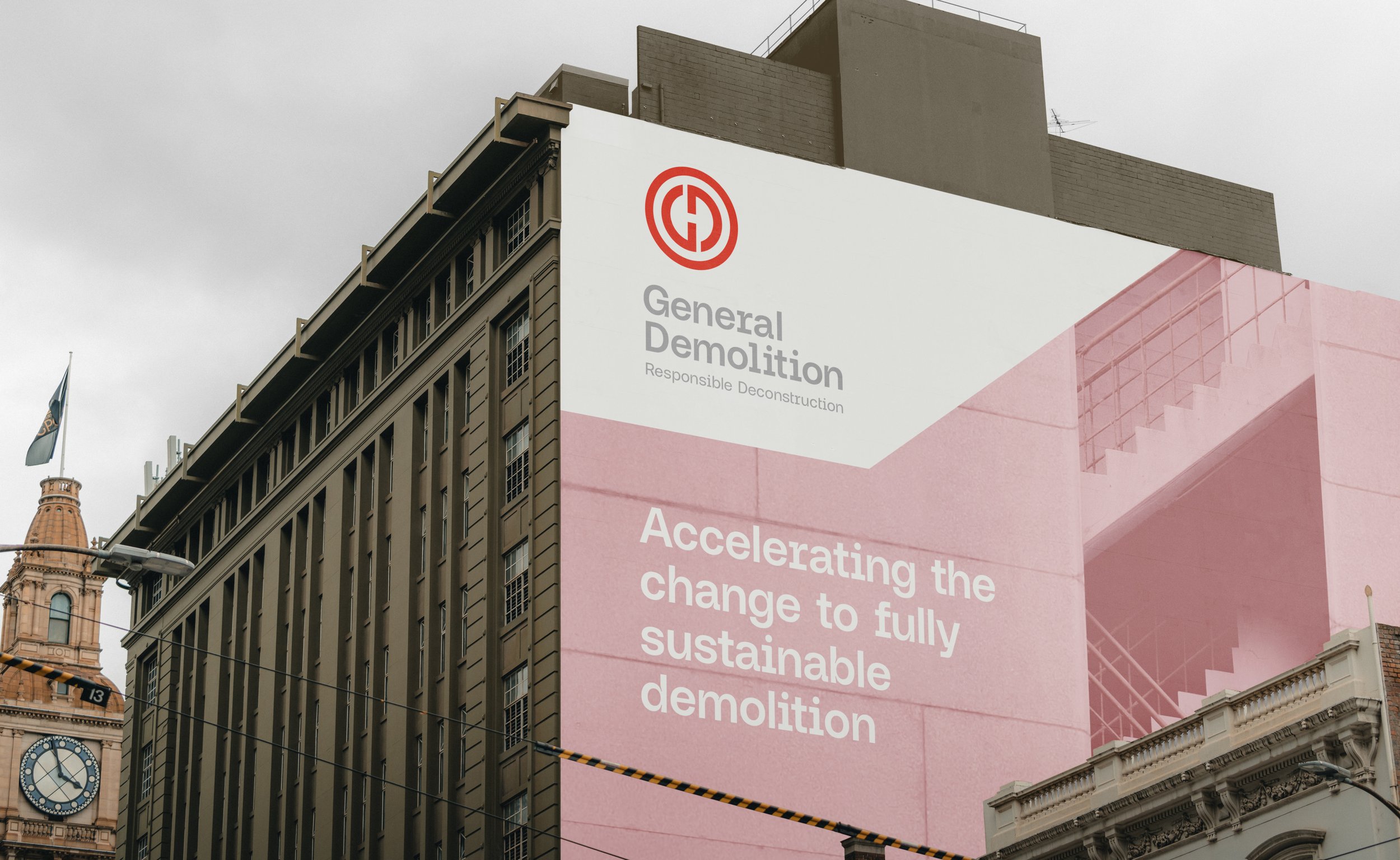Large building with "General Demolition" advertisement promoting sustainable demolition, visible clock tower and flag.