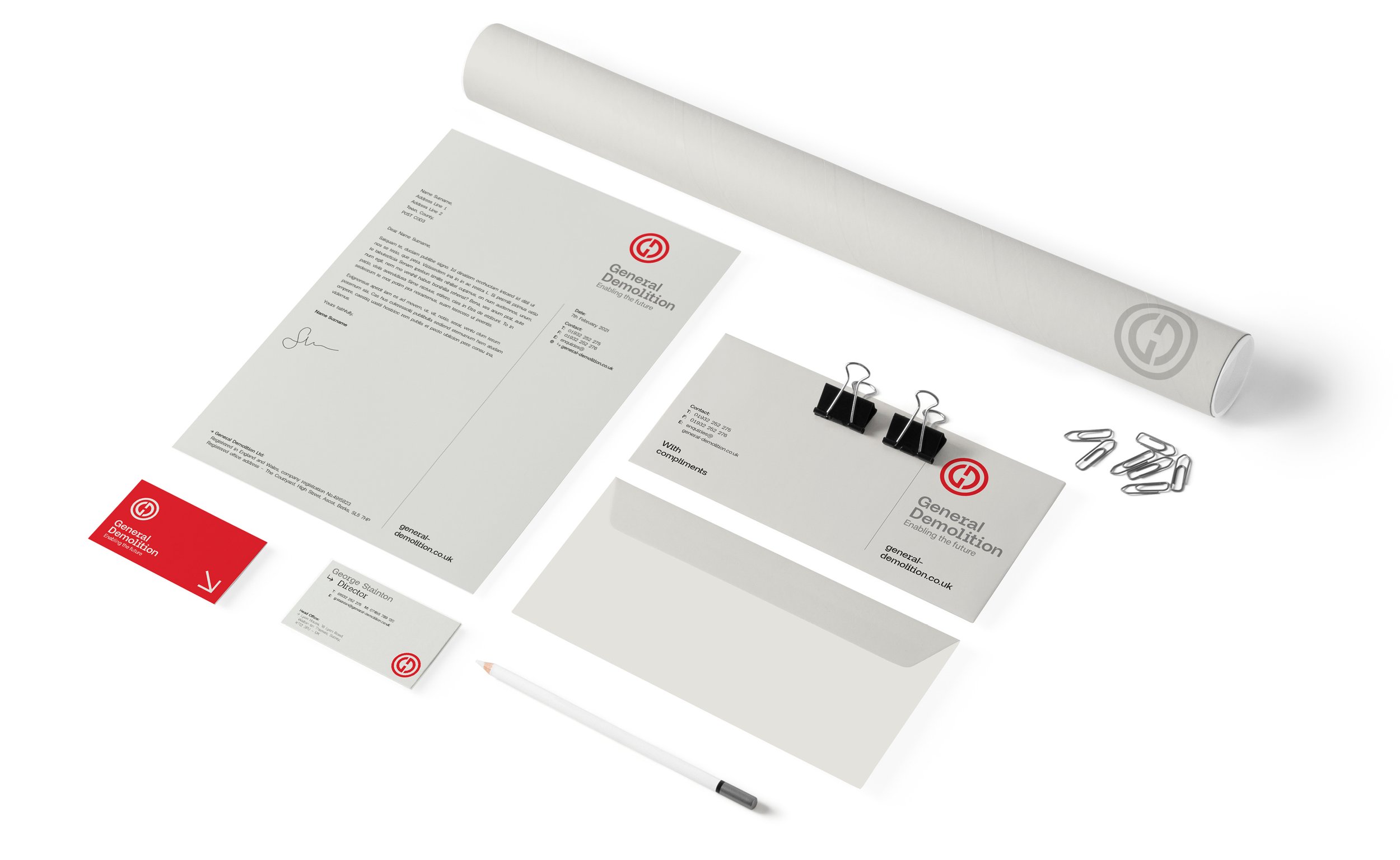 Corporate stationery set with letterhead, business cards, envelope, and office supplies.