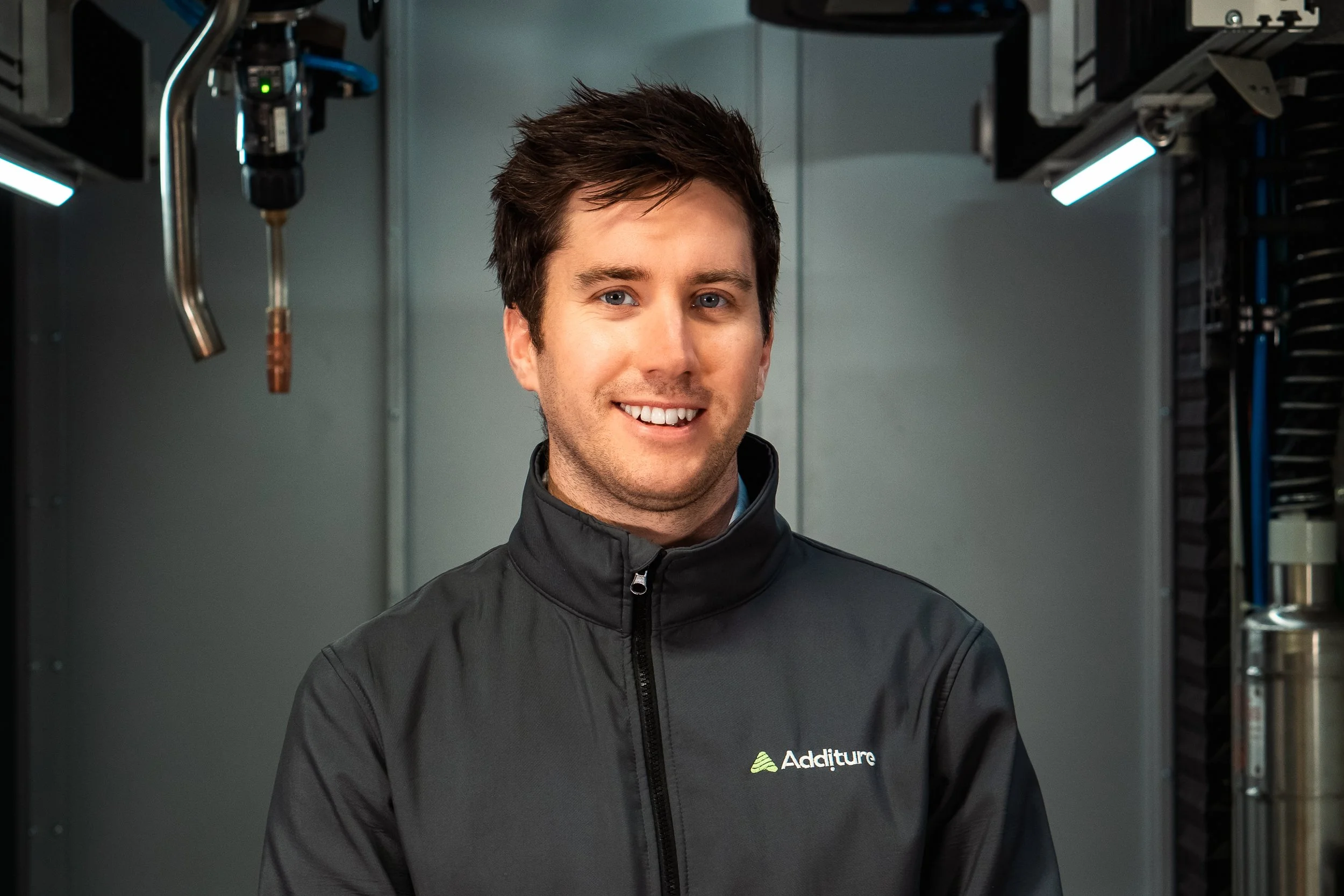 Person wearing an Additure jacket in a technological setting