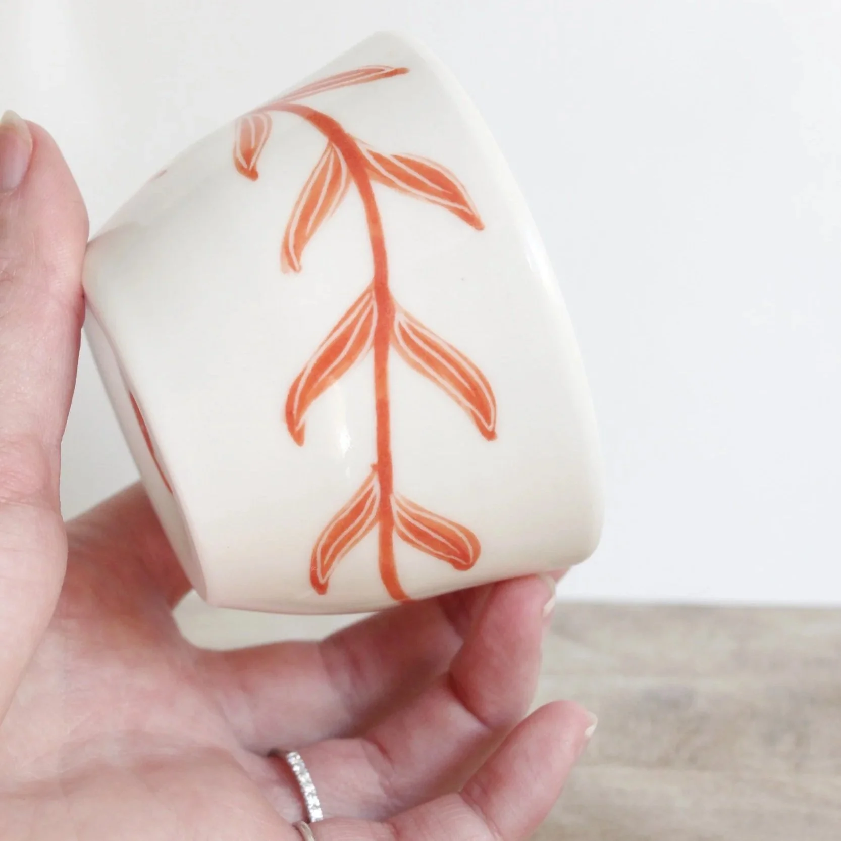 Porcelain cup with red leaves