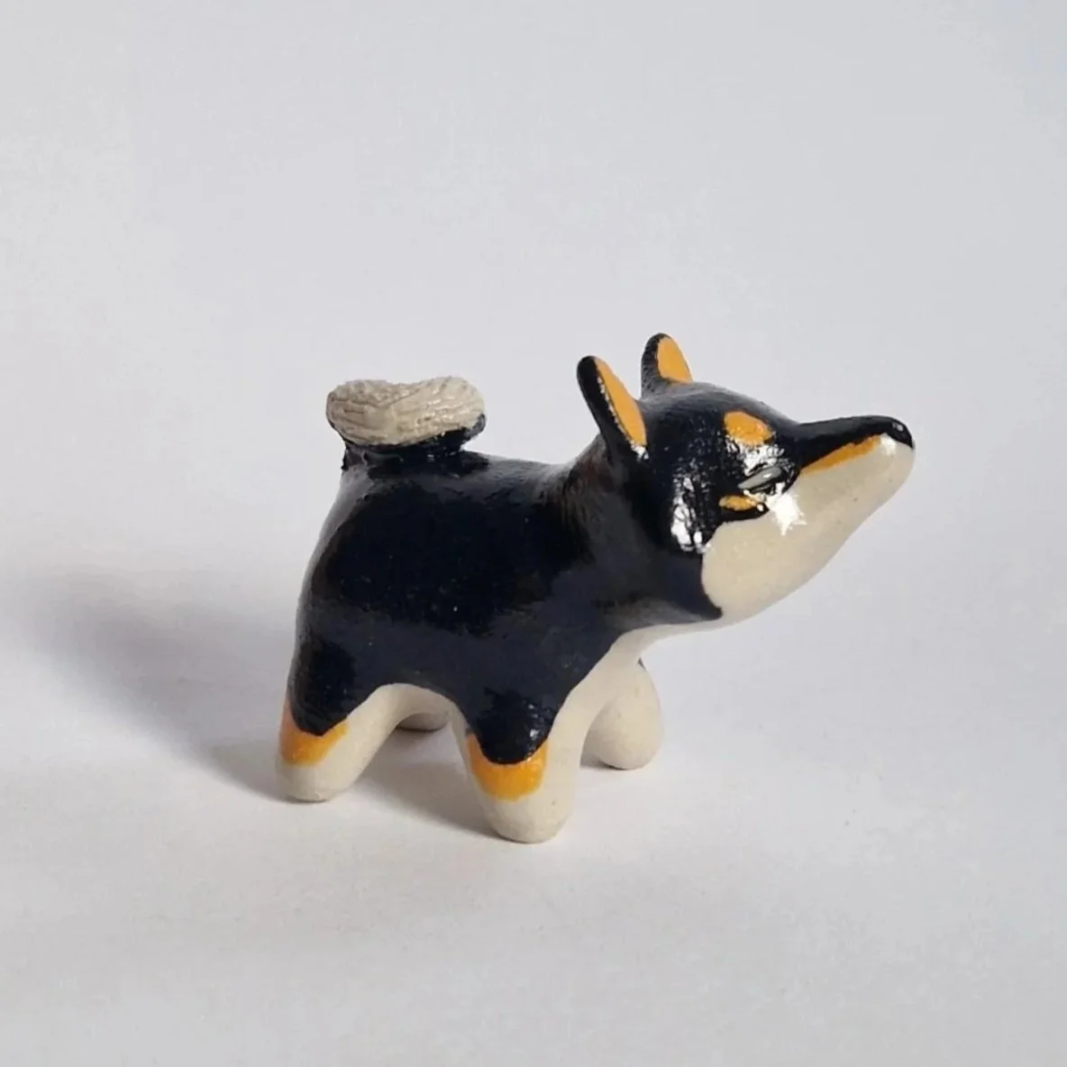 Stoneware mini shiba inu figurine, black and tan