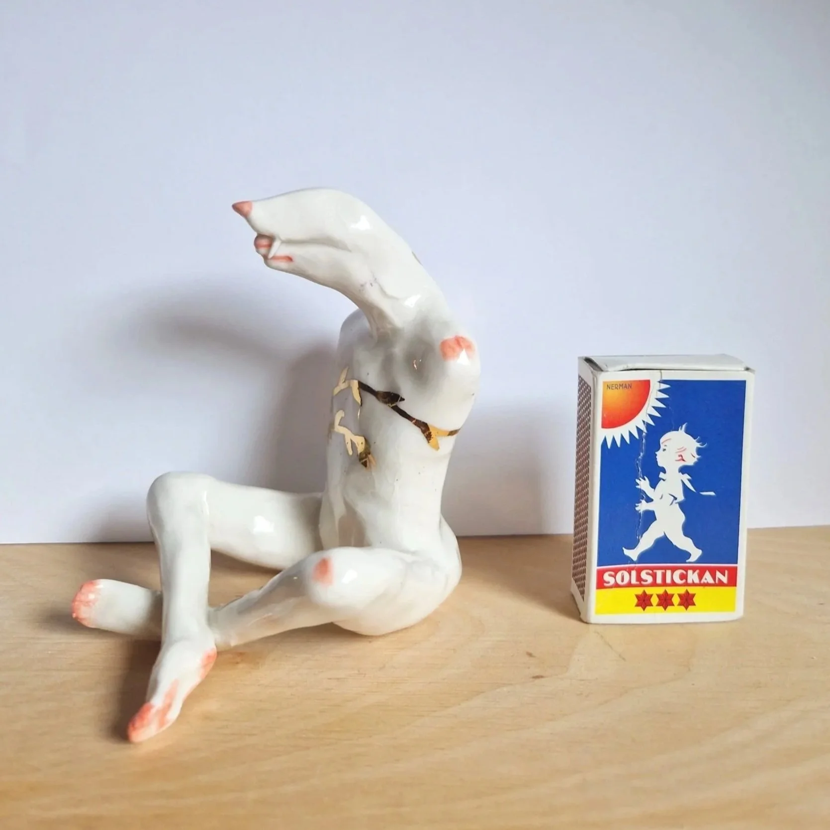 Porcelain sculpture with gold luster