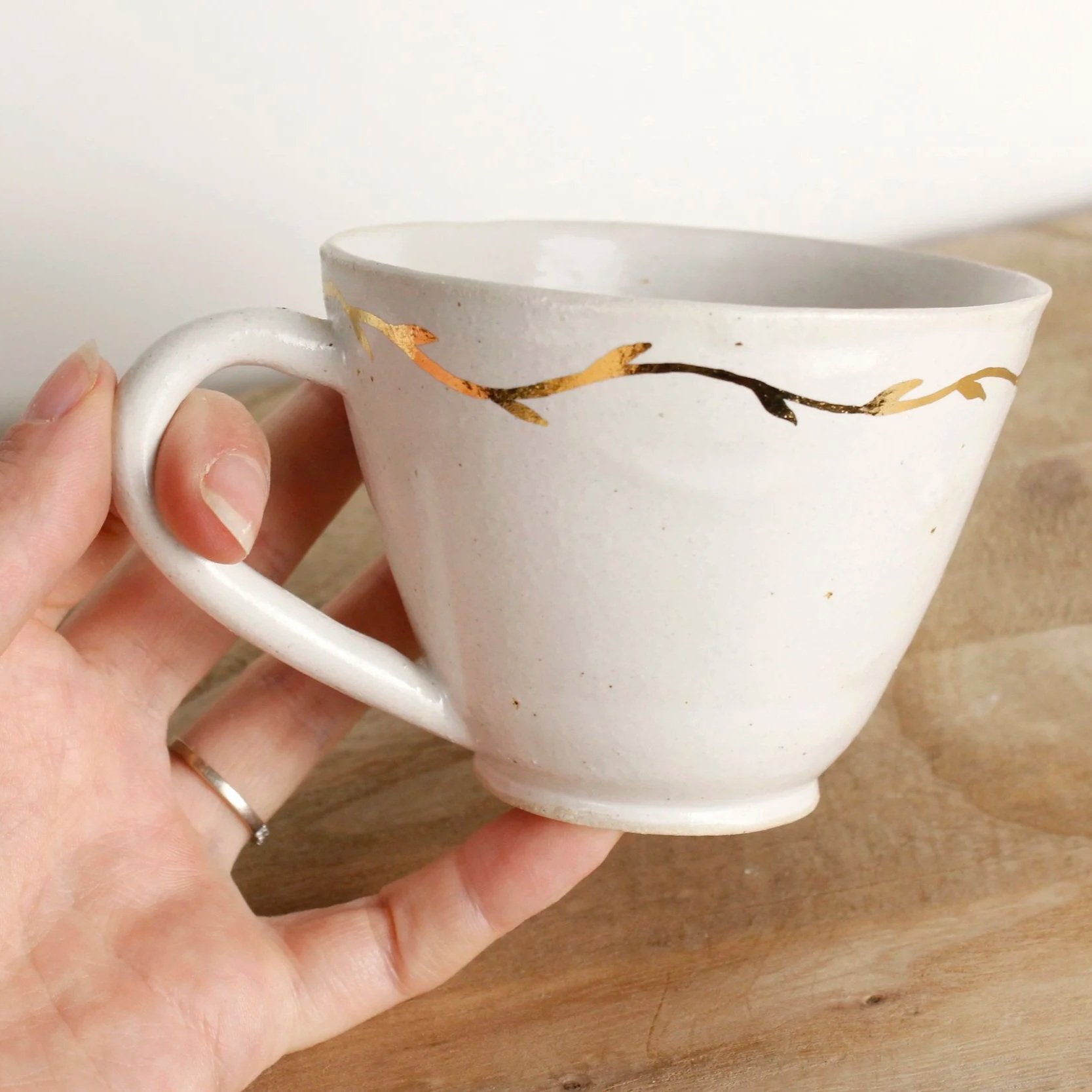 White stoneware mug with gold