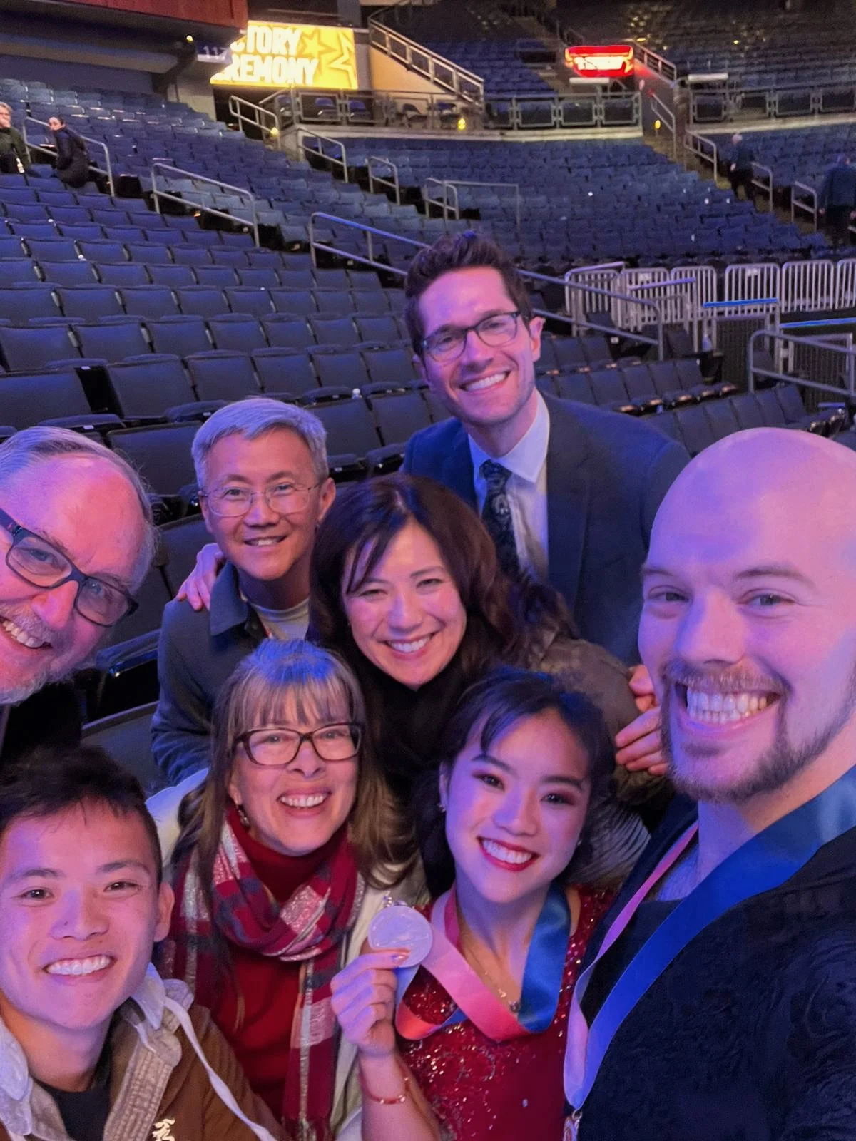 A blended family photo of the Kam's and O'Shea's with Coach Drew Meekins
