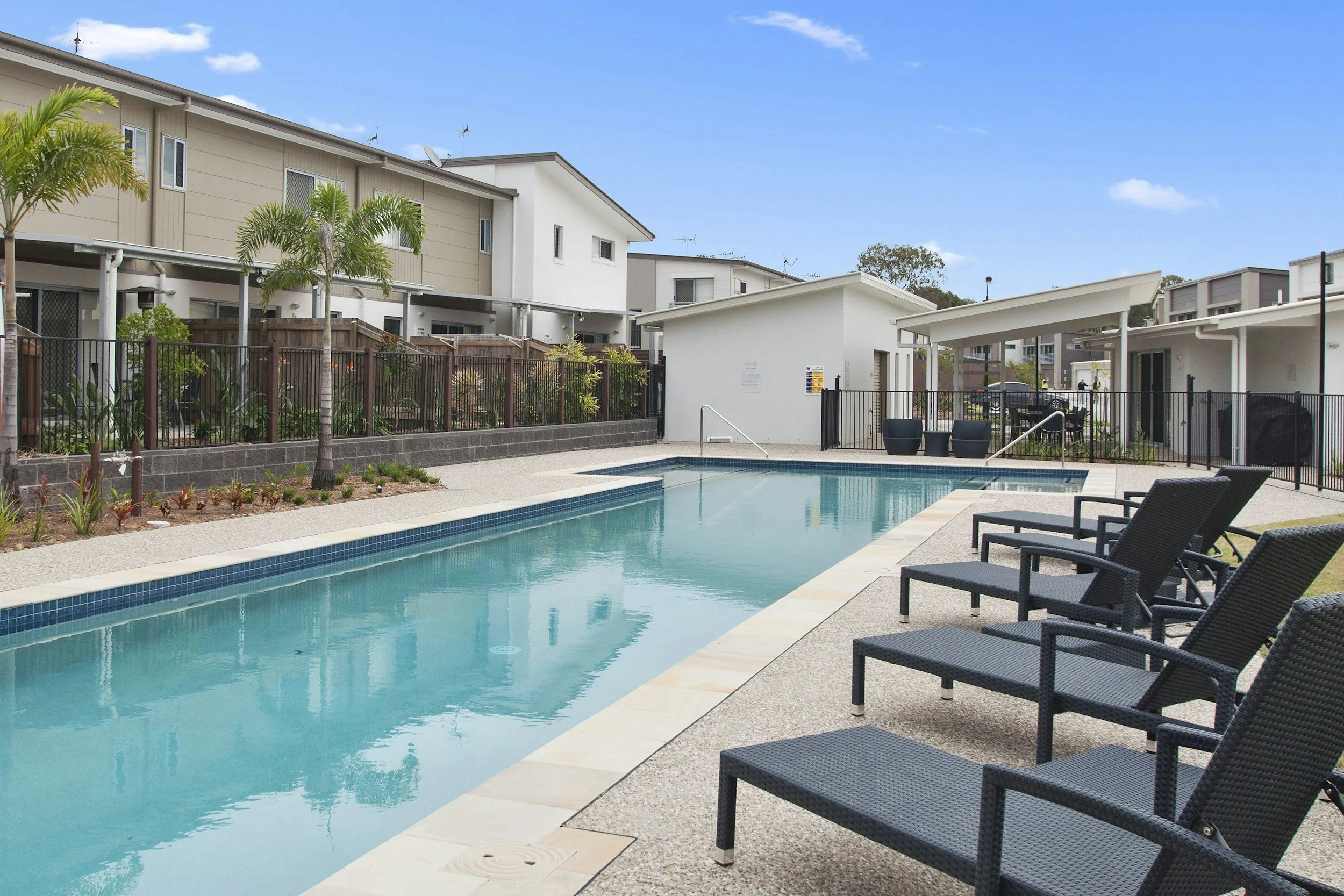 Residential community swimming pool and surrounding concrete pool deck