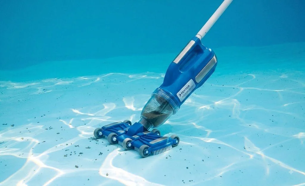 Pool vacuum cleaning the bottom of a swimming pool